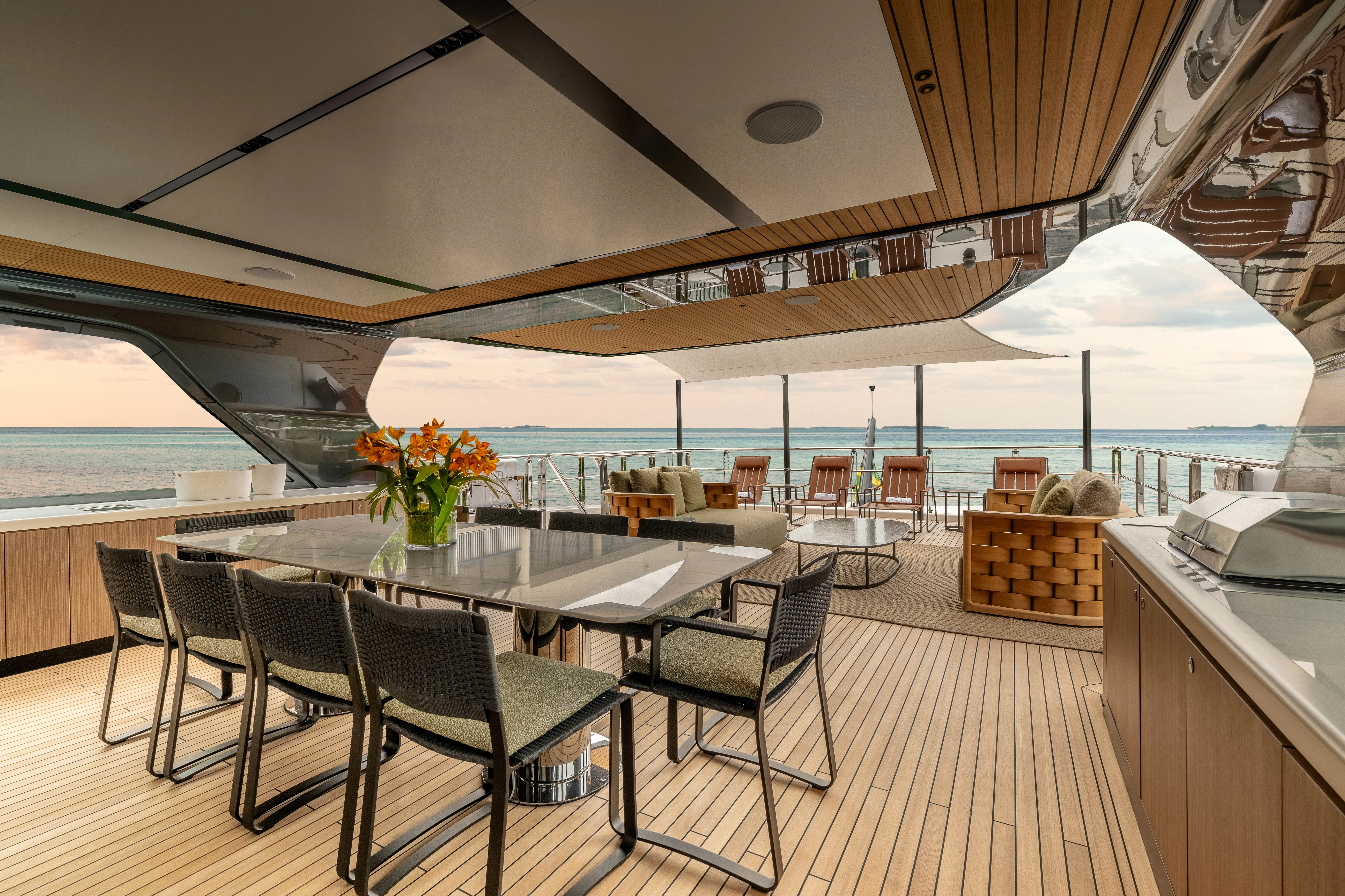 a large room with a table and chairs and a large umbrella aboard ANDREIKA V Yacht for Charter