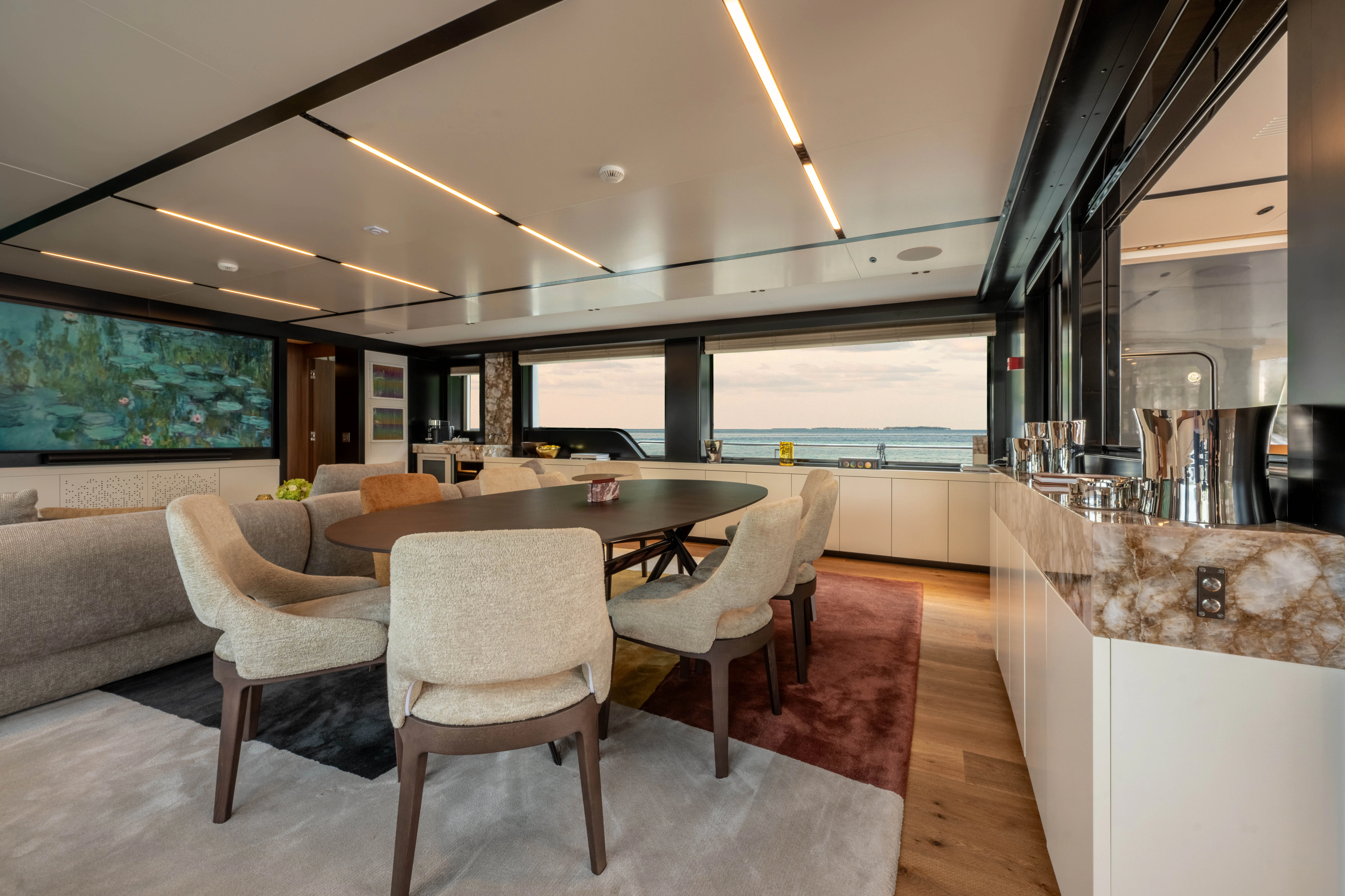 a modern looking kitchen with a large table and chairs aboard ANDREIKA V Yacht for Charter