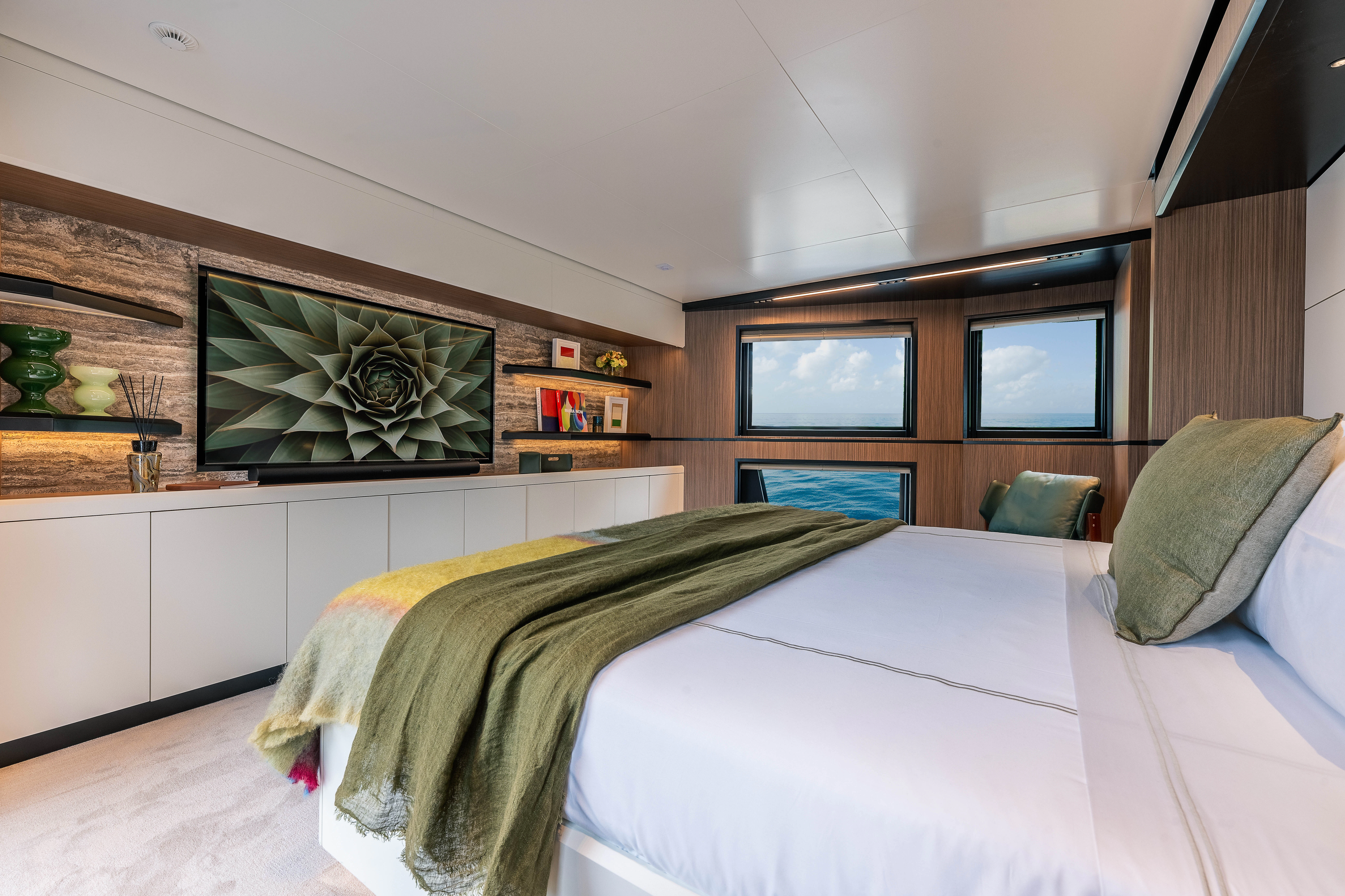 a bedroom with a bed and a television aboard ANDREIKA V Yacht for Charter