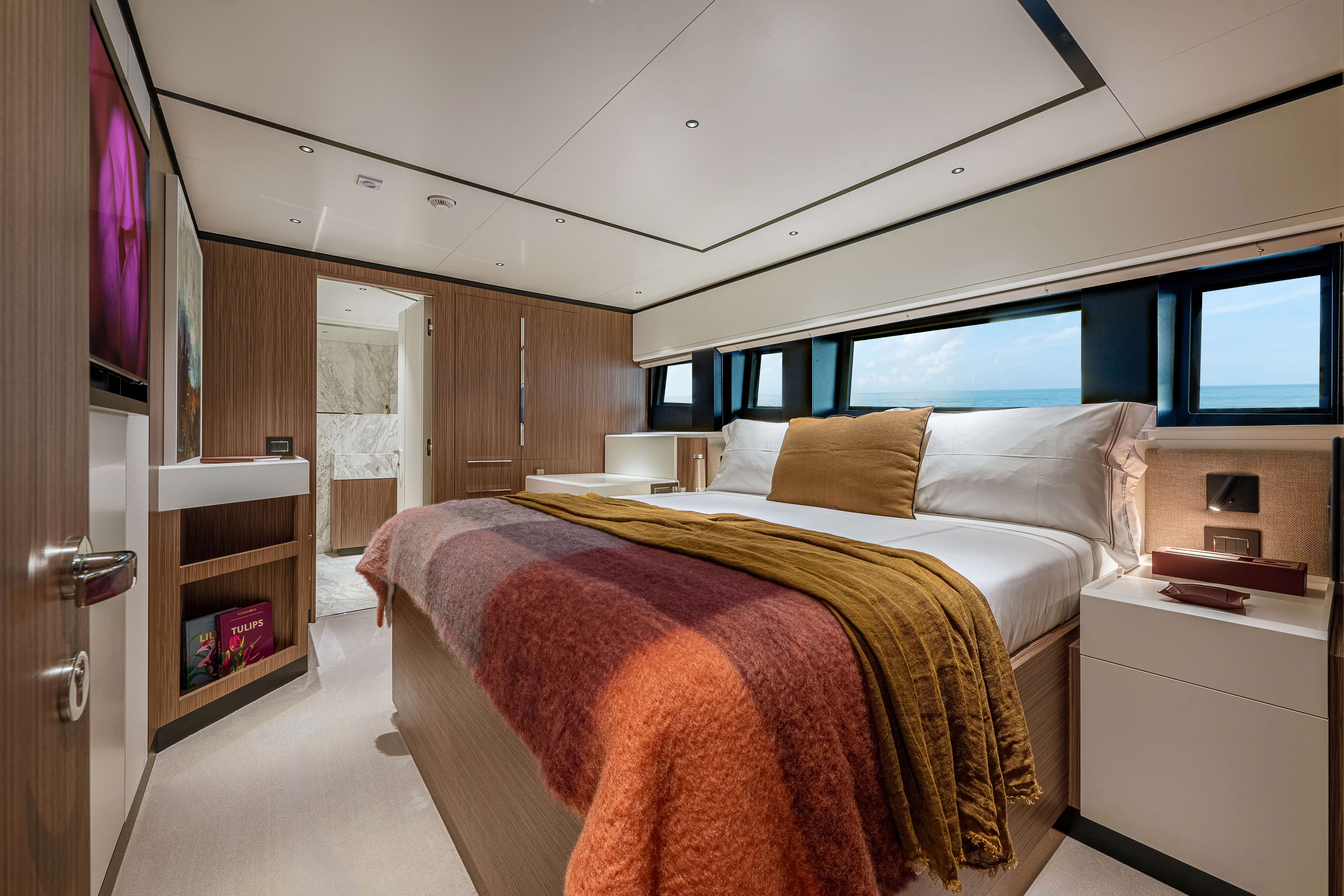 a bedroom with a large bed aboard ANDREIKA V Yacht for Charter