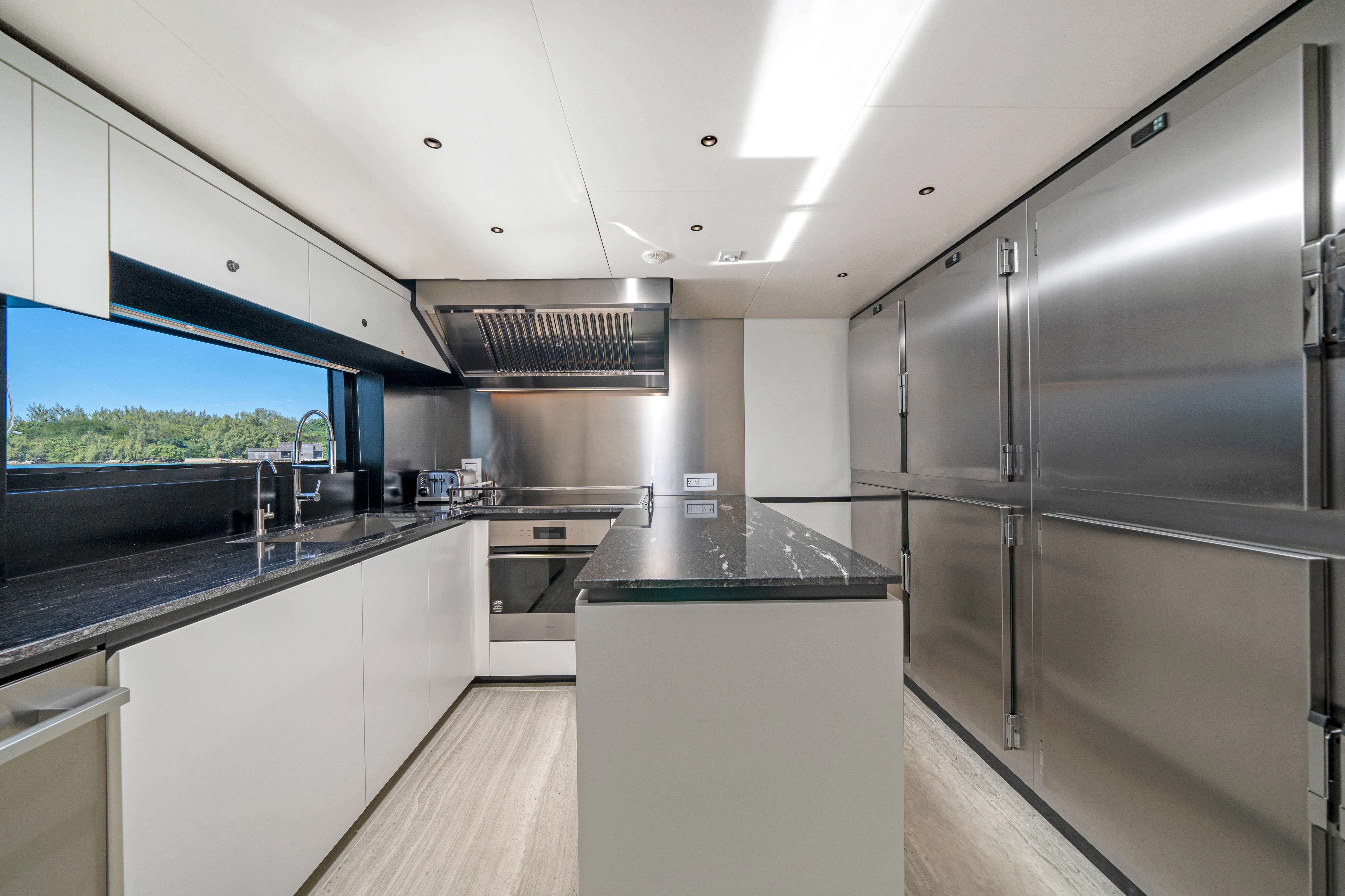 a kitchen with a large window aboard ANDREIKA V Yacht for Charter