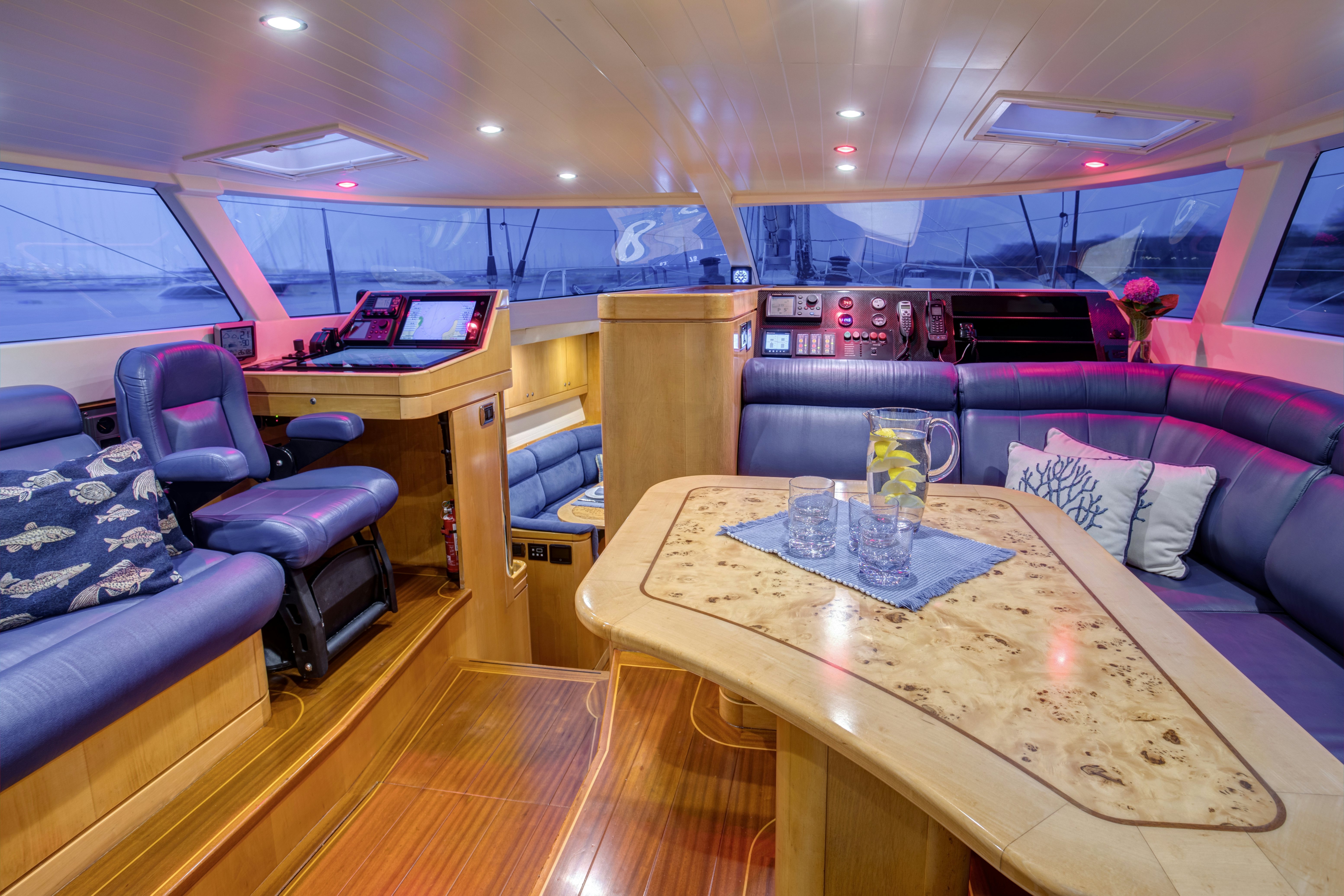 a room with a table and chairs aboard LADY K Yacht for Sale
