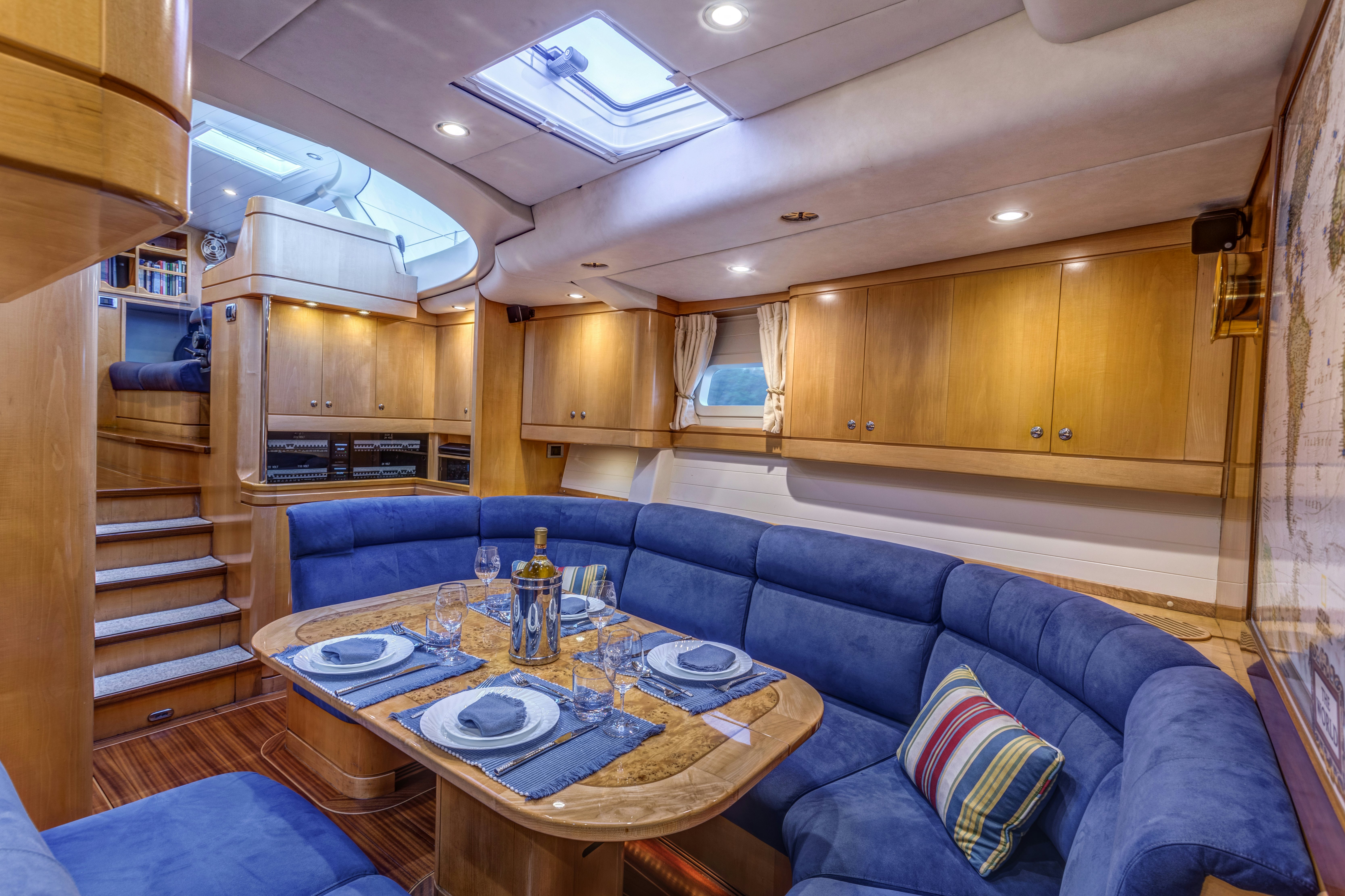 a living room with a wood staircase aboard LADY K Yacht for Sale