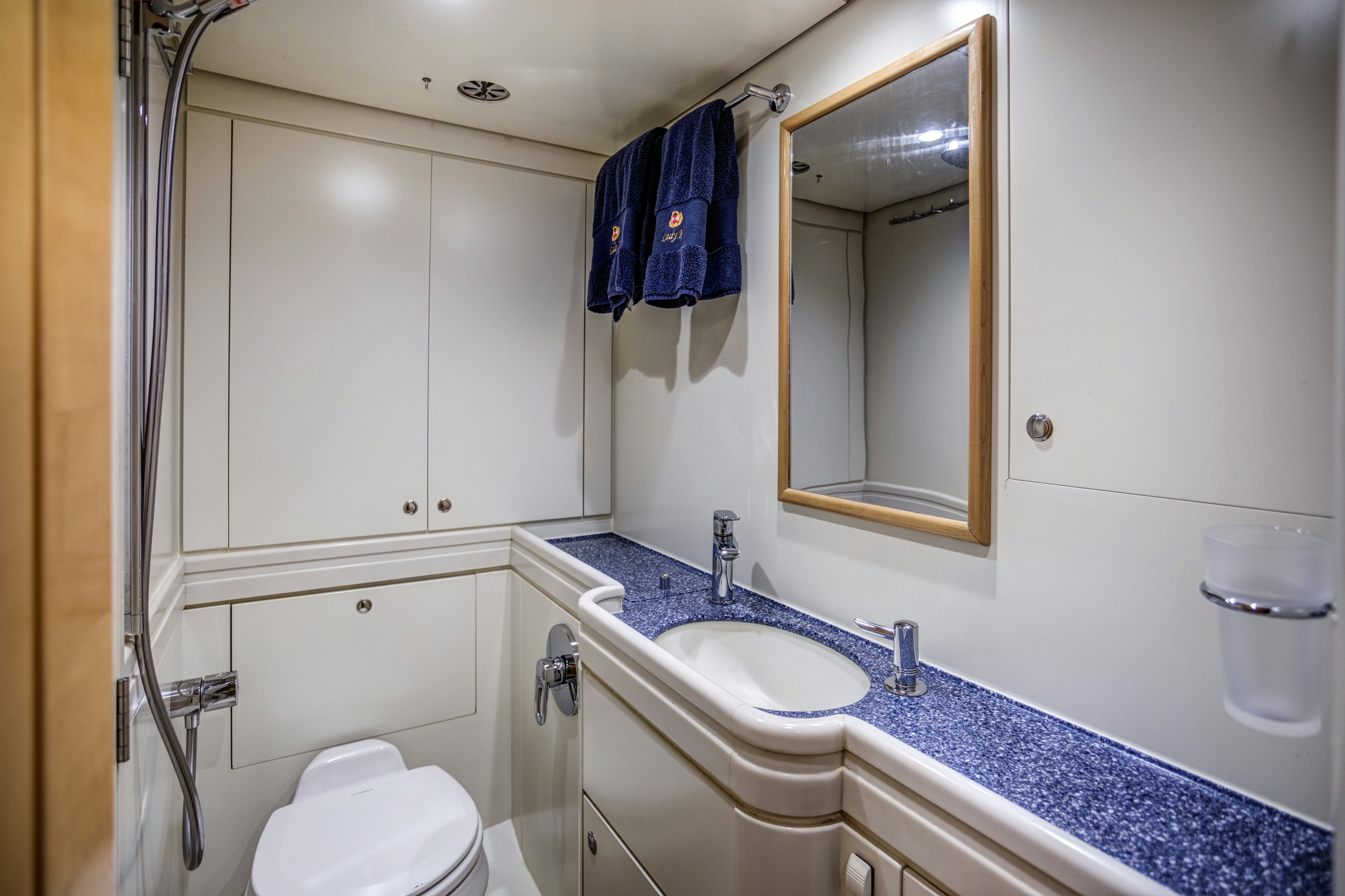 a bathroom with a sink and a mirror aboard LADY K Yacht for Sale