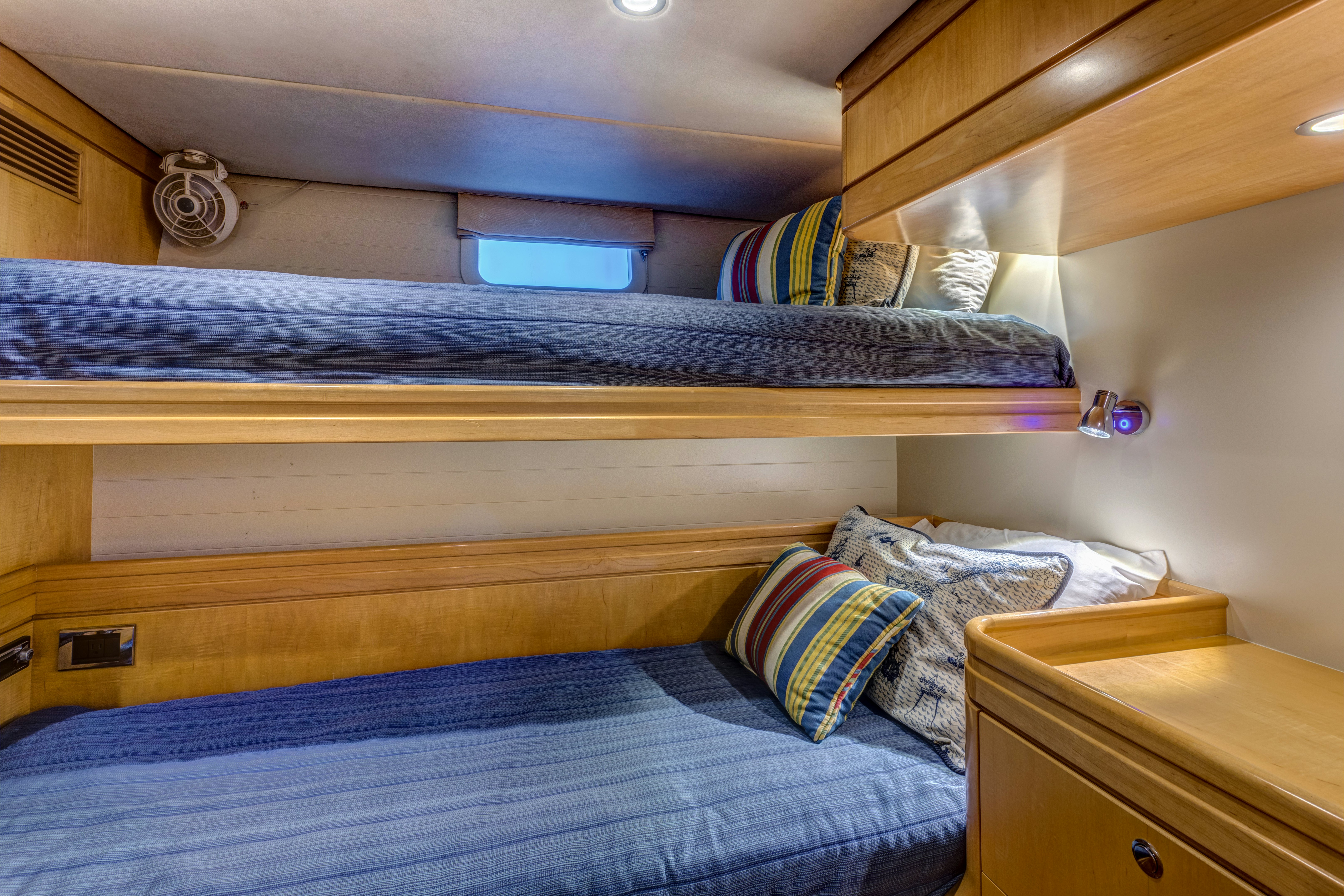 a bed with a blue comforter aboard LADY K Yacht for Sale
