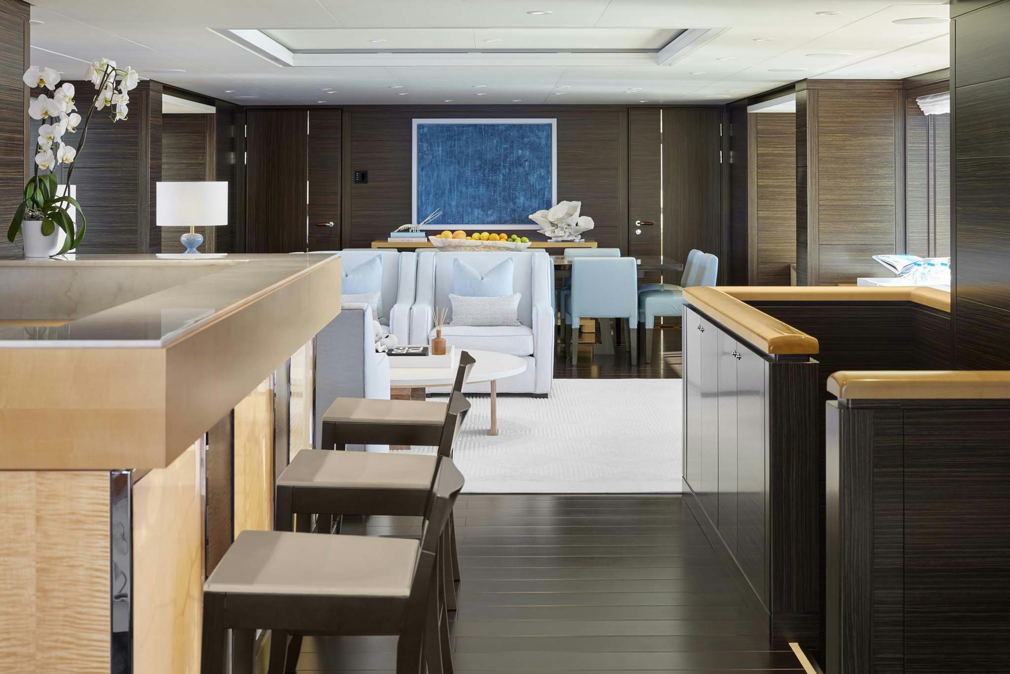 a room with tables and chairs aboard REVELRY Yacht for Charter