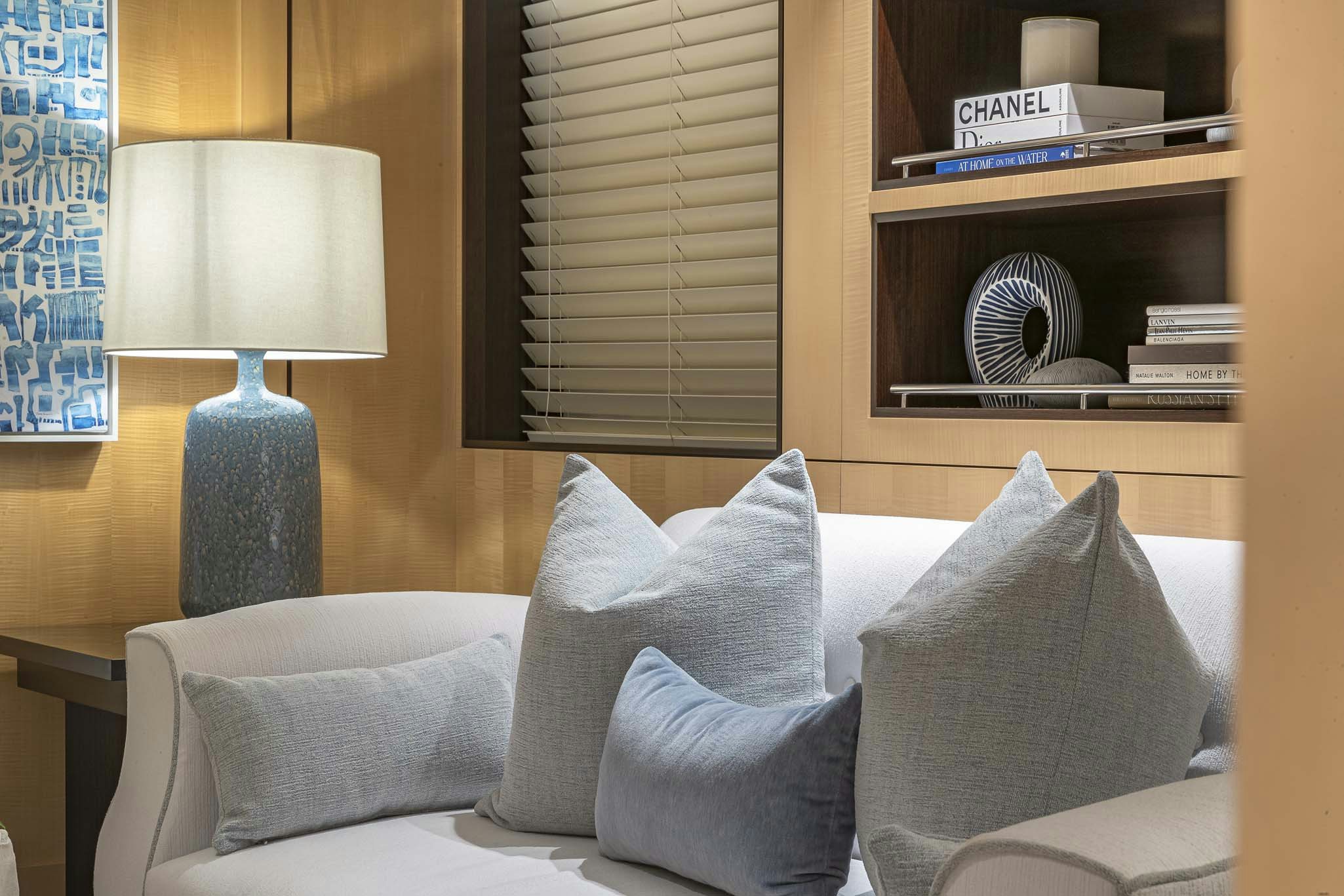 a room with a couch and a lamp aboard REVELRY Yacht for Charter