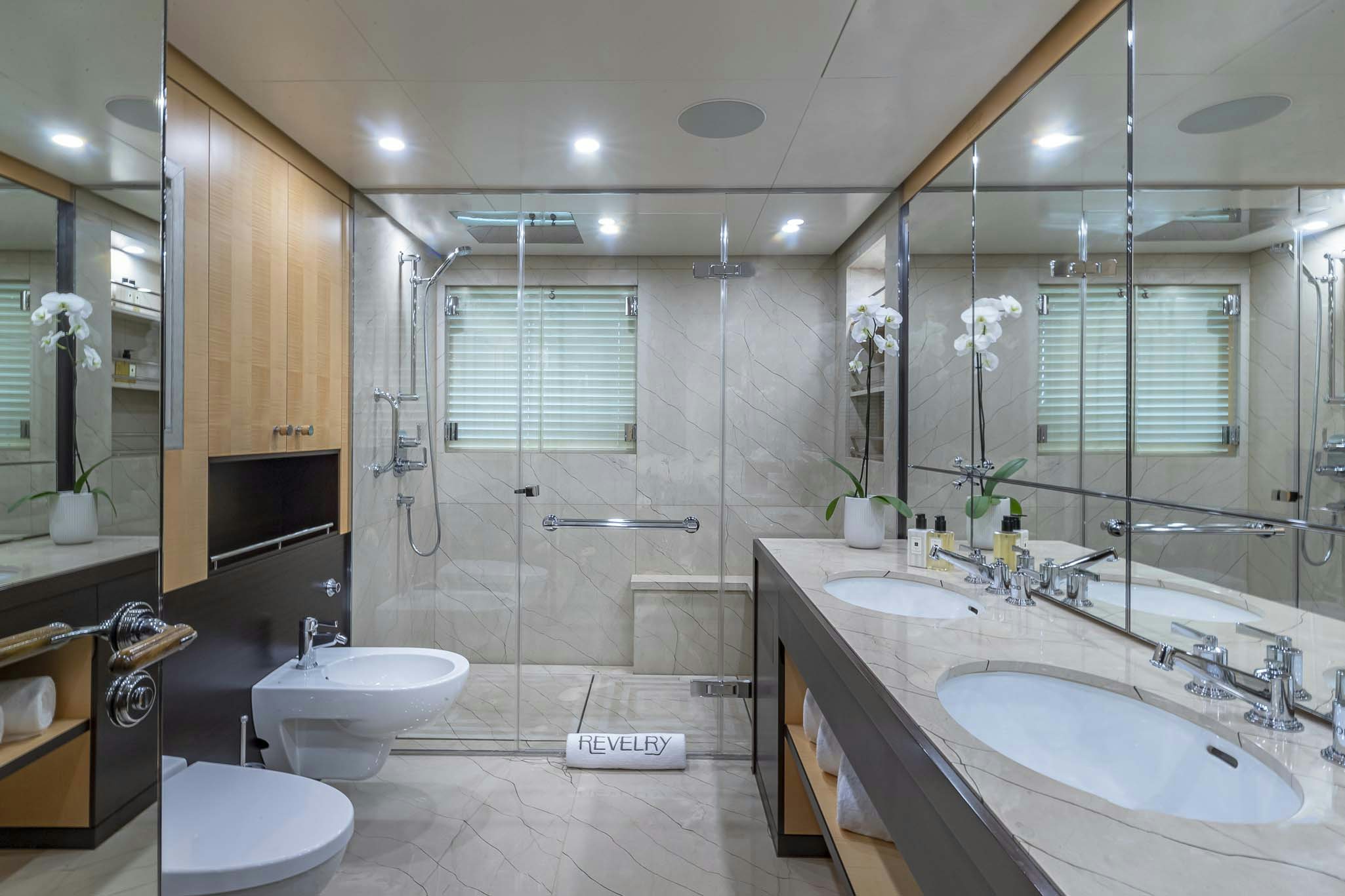 a bathroom with a large glass shower aboard REVELRY Yacht for Charter