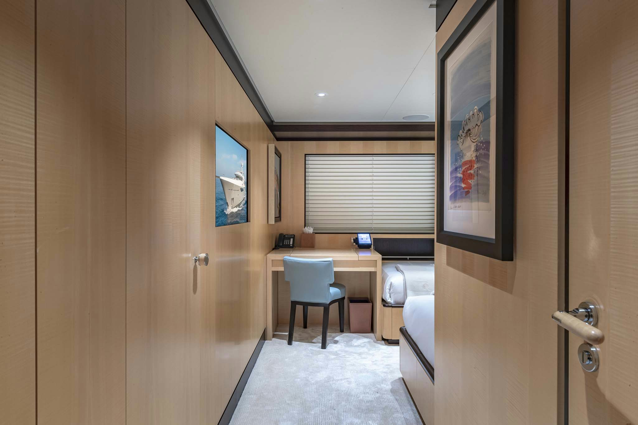 a room with a desk and a chair aboard REVELRY Yacht for Charter