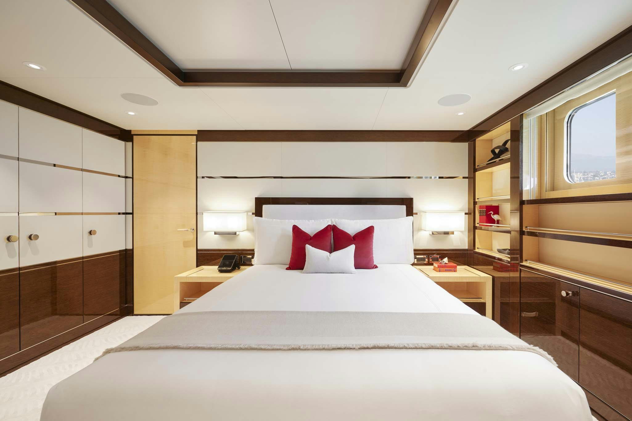 a bedroom with a bed and a mirror aboard REVELRY Yacht for Charter