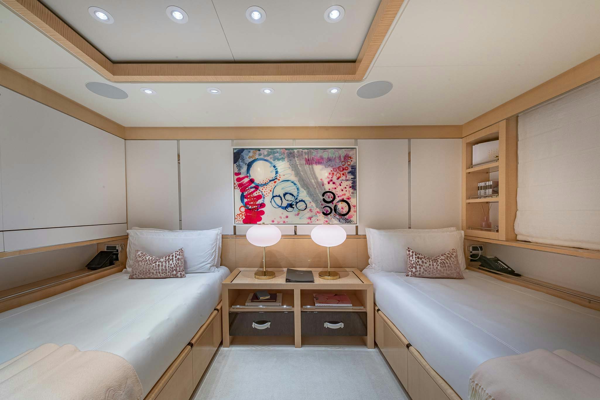 a bedroom with a bed and a desk aboard REVELRY Yacht for Charter