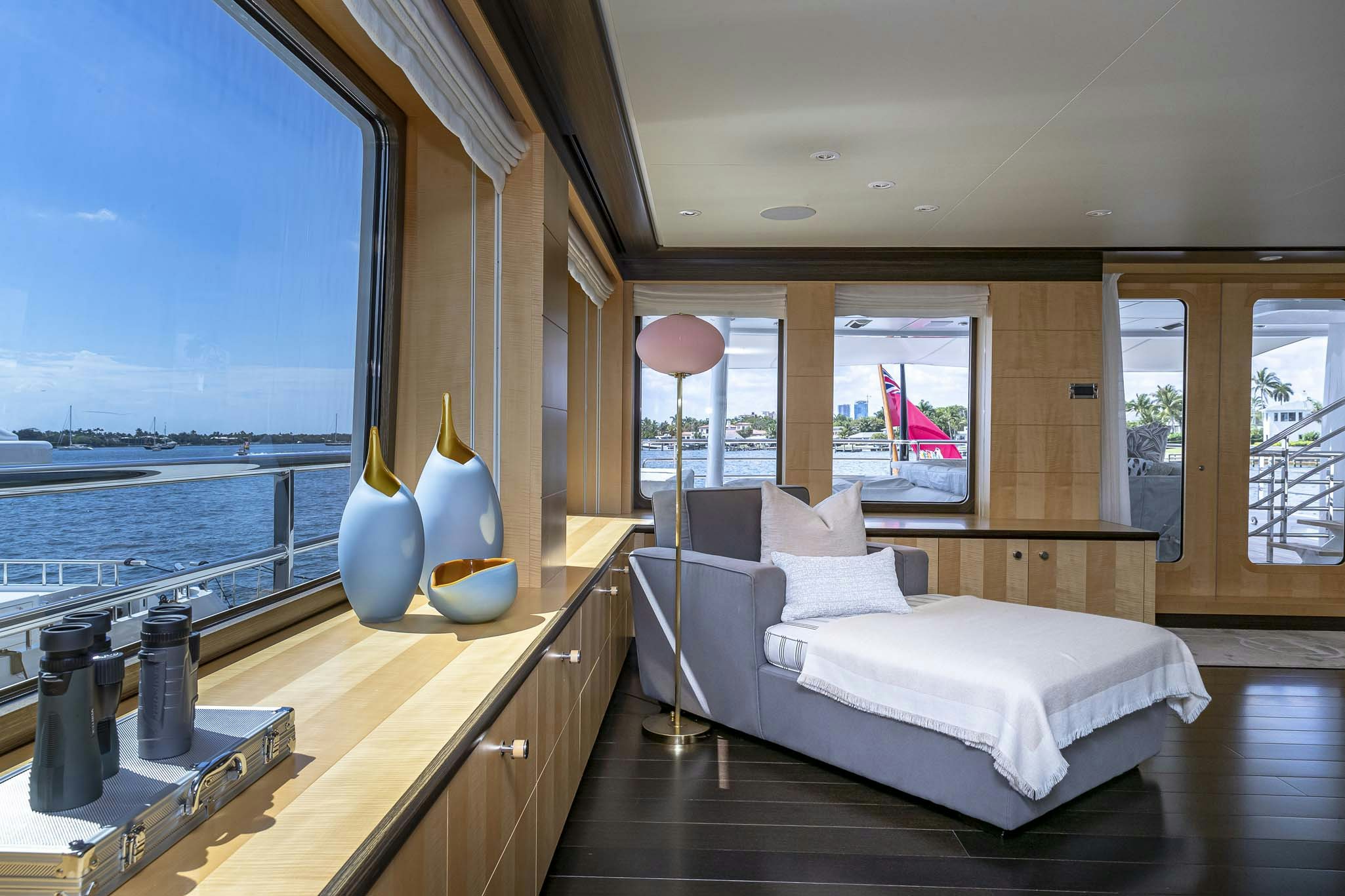 a room with a bed and a large window aboard REVELRY Yacht for Charter