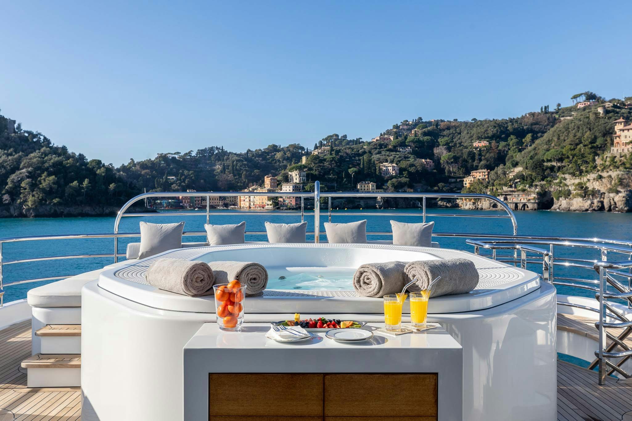 a pool with a table and chairs aboard REVELRY Yacht for Charter