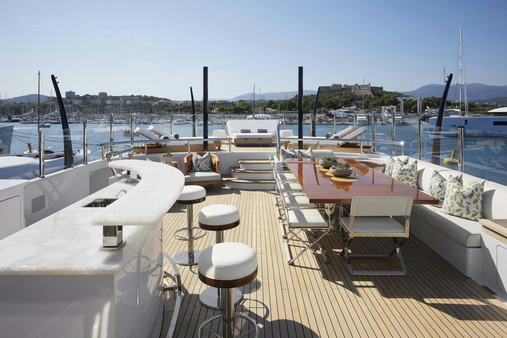 a deck with tables and chairs on it aboard REVELRY Yacht for Charter