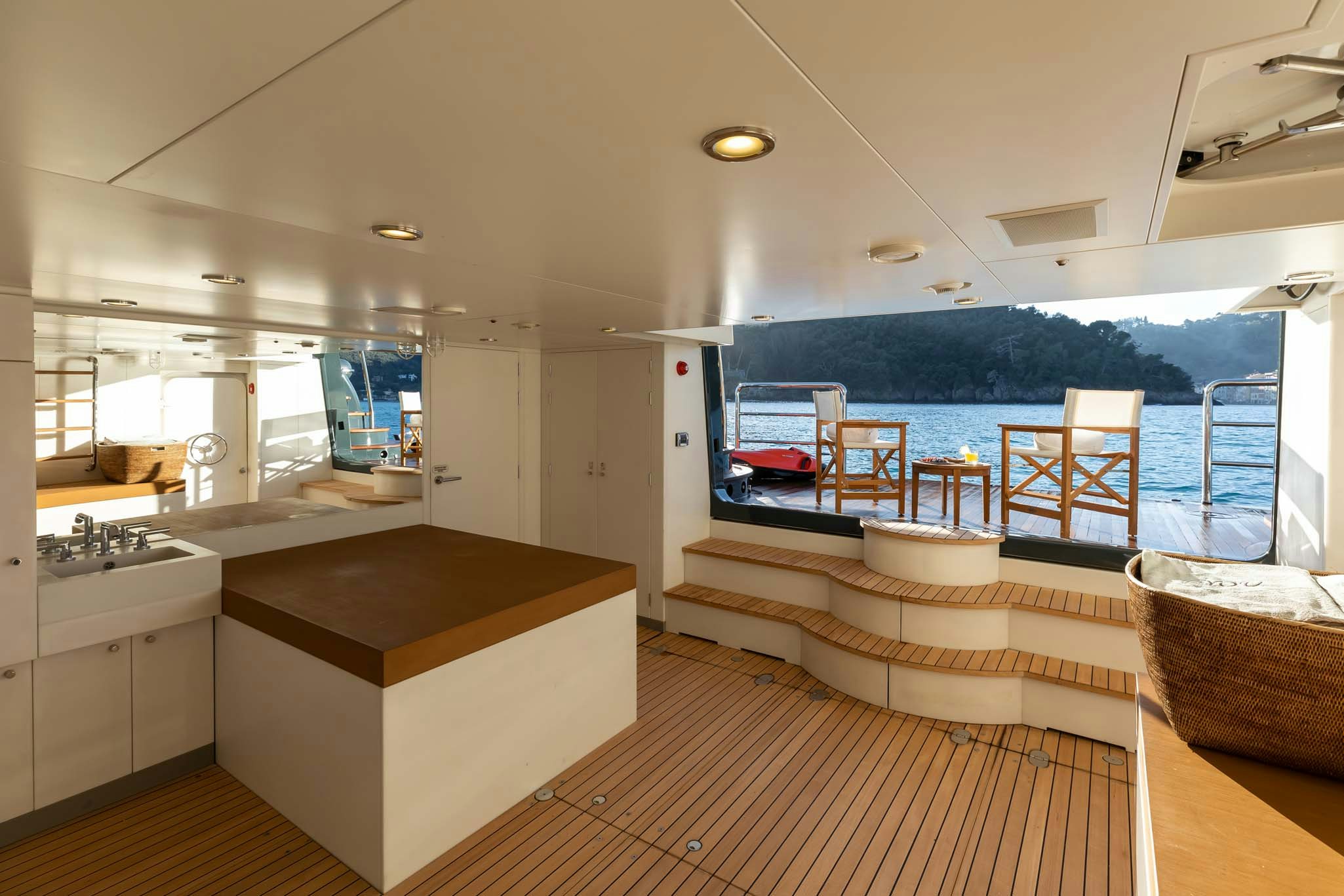 a modern looking kitchen with a view of the ocean aboard REVELRY Yacht for Charter