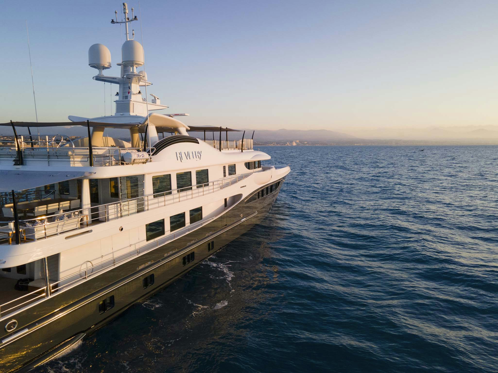 a large white boat on the water aboard REVELRY Yacht for Charter
