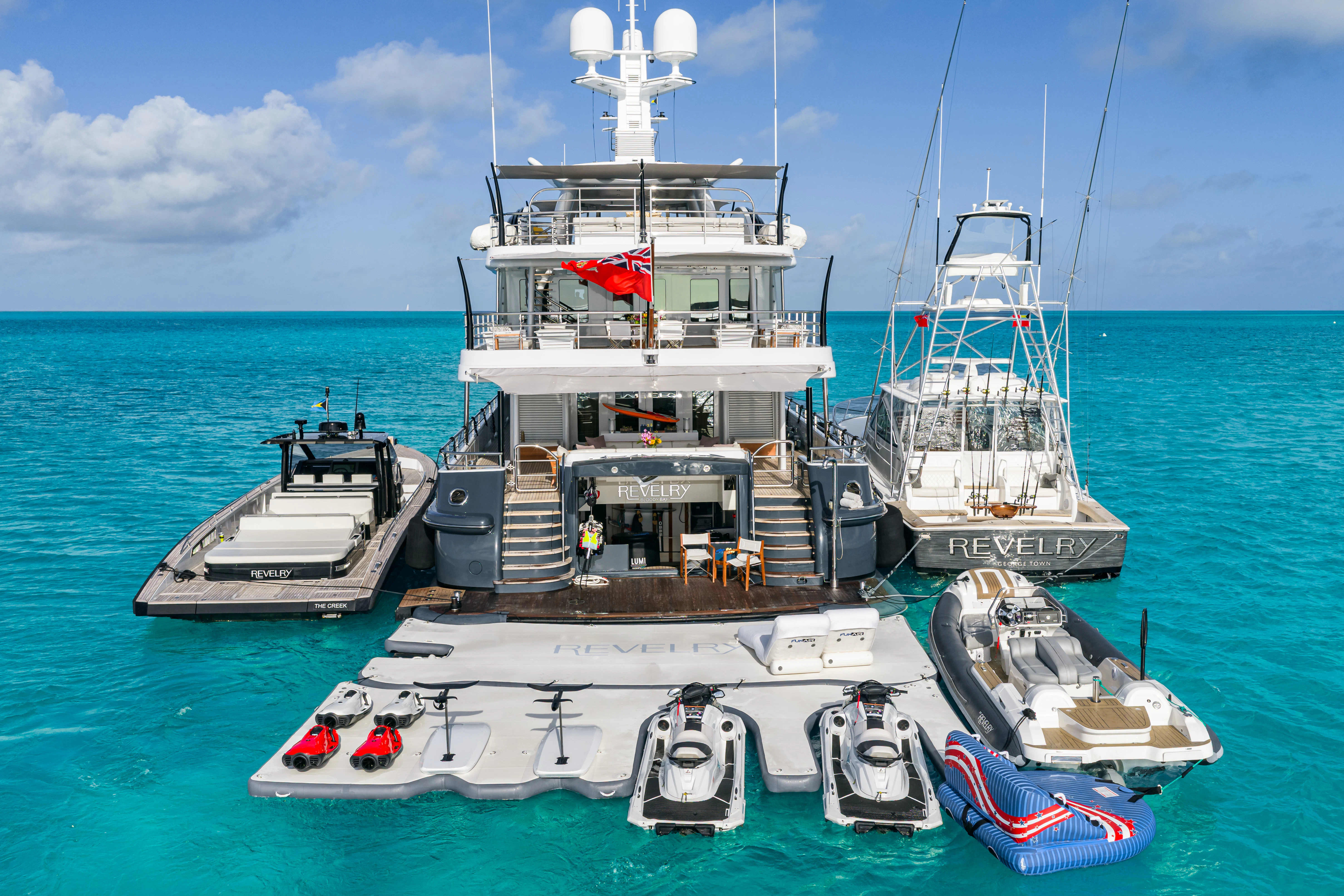 a group of boats are parked on a dock aboard REVELRY Yacht for Charter