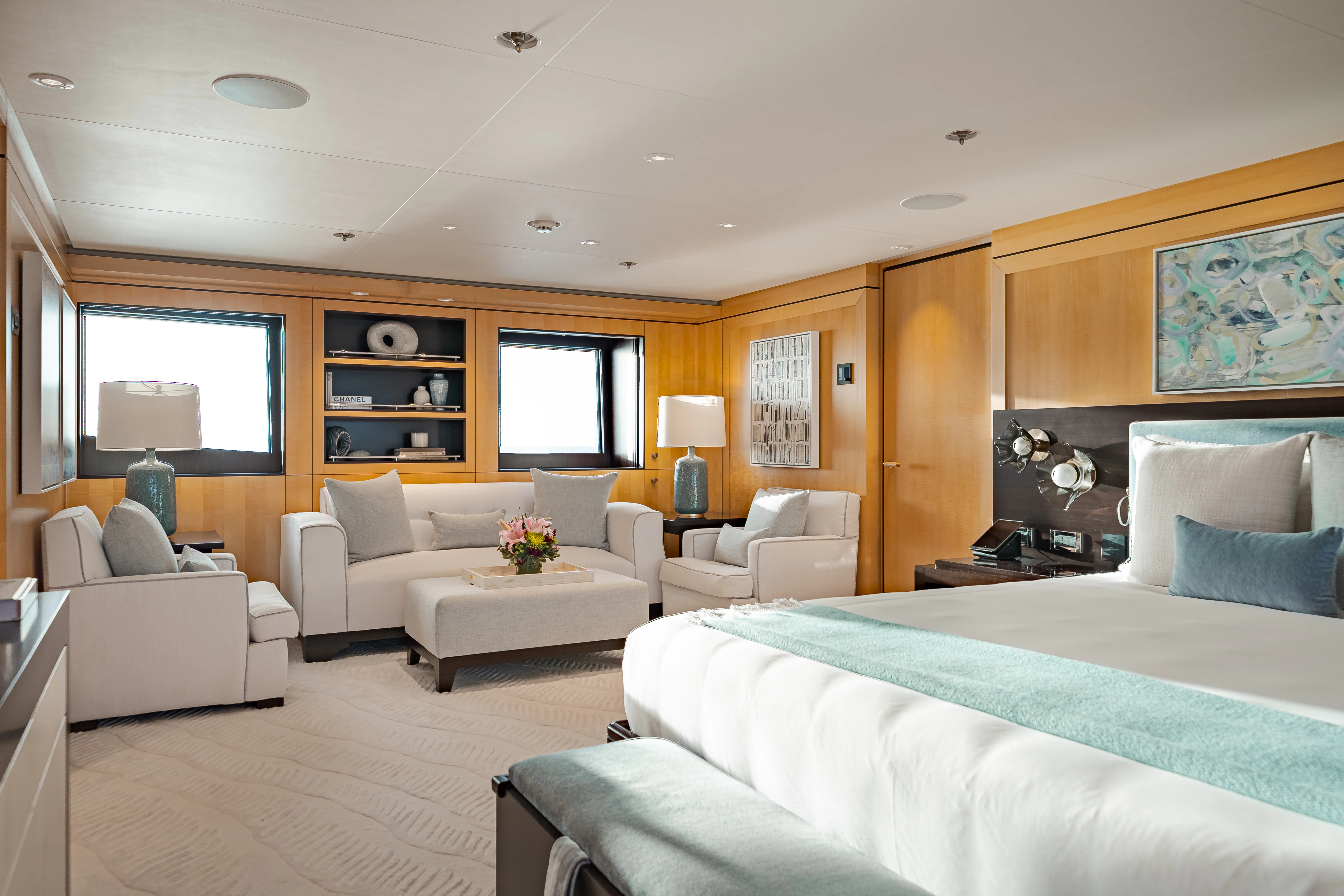 a large bedroom with a bed and a couch aboard REVELRY Yacht for Charter