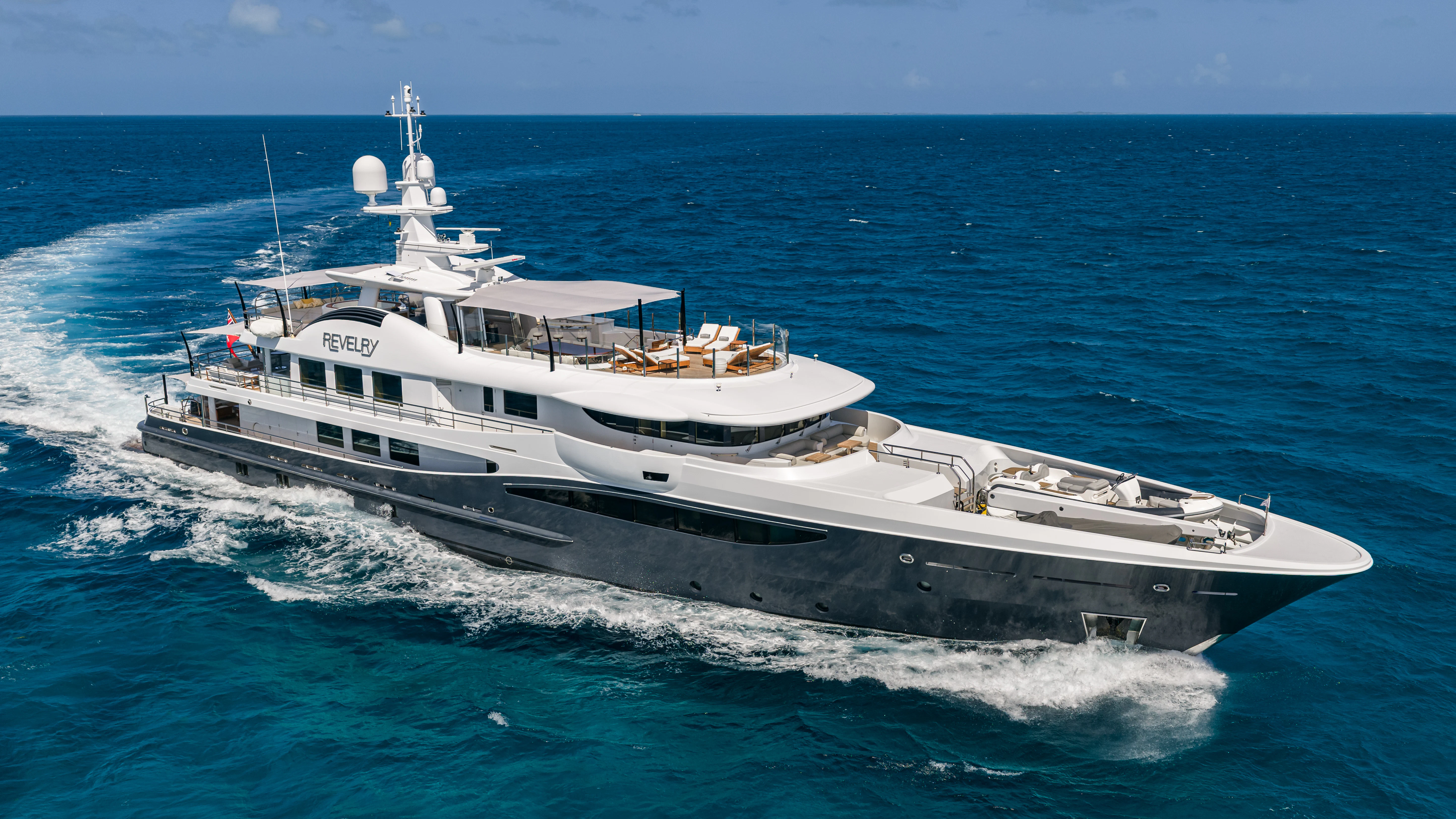 a large white boat in the water aboard REVELRY Yacht for Charter