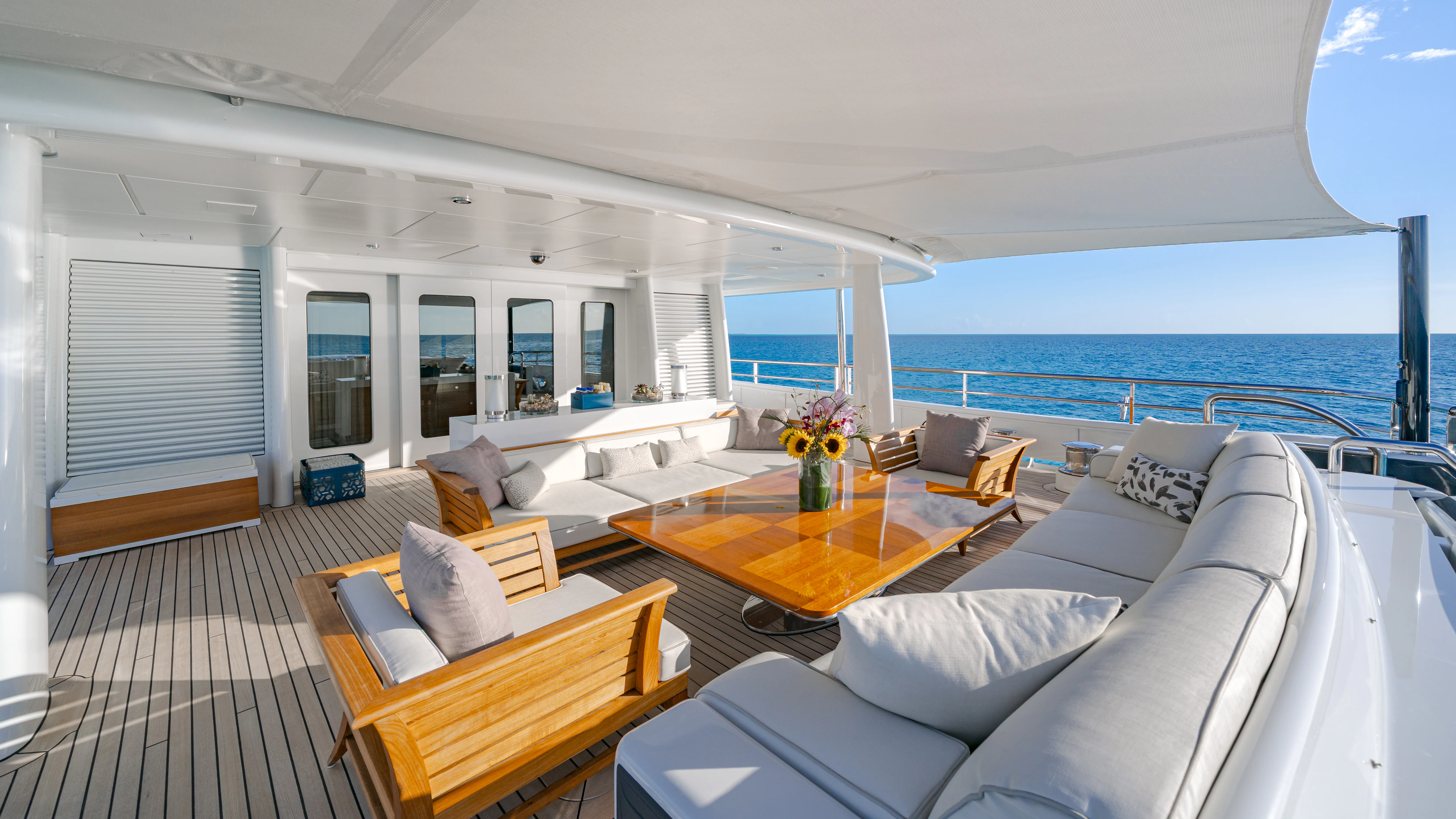 a living room with a large balcony aboard REVELRY Yacht for Charter
