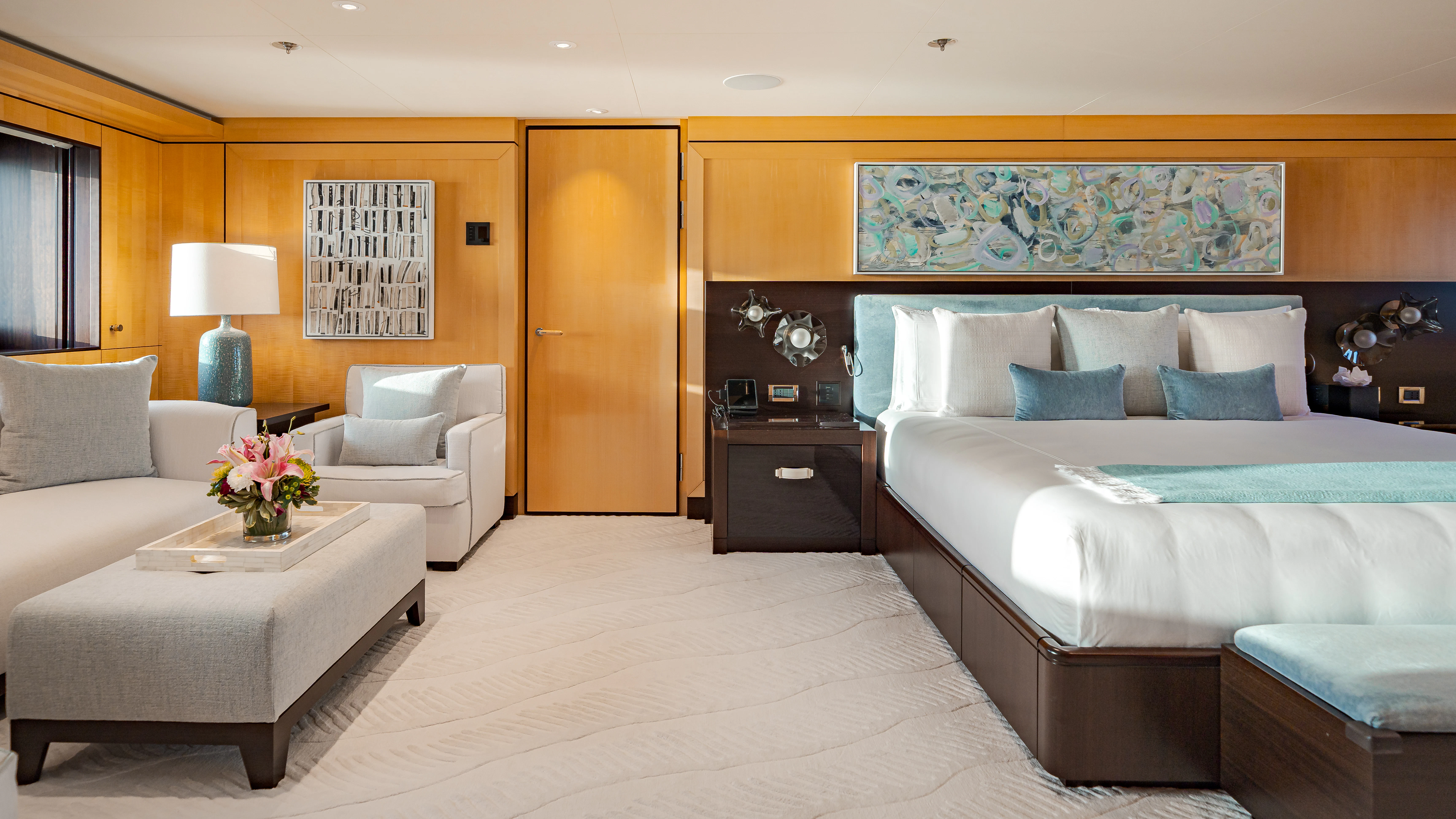 a bedroom with a bed and a couch aboard REVELRY Yacht for Charter