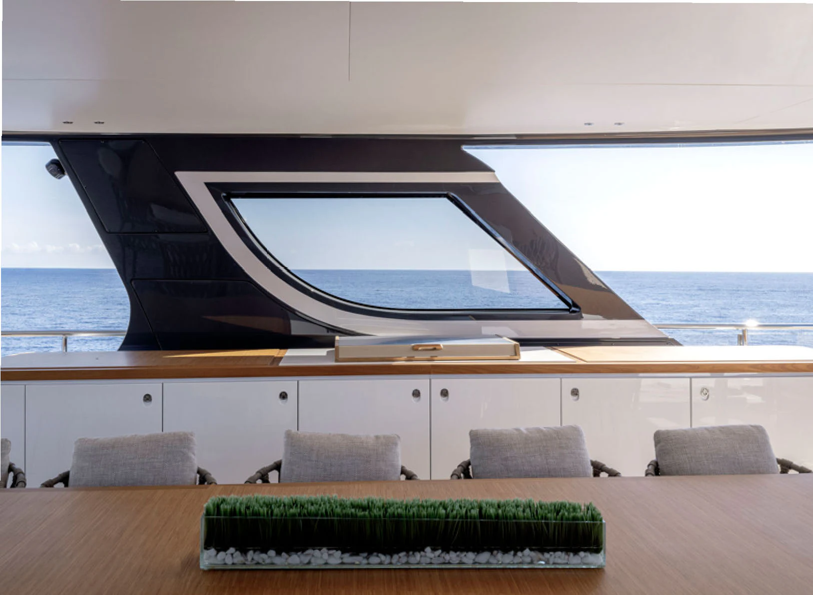 a large glass window above a wooden table aboard CADA DIA Yacht for Charter