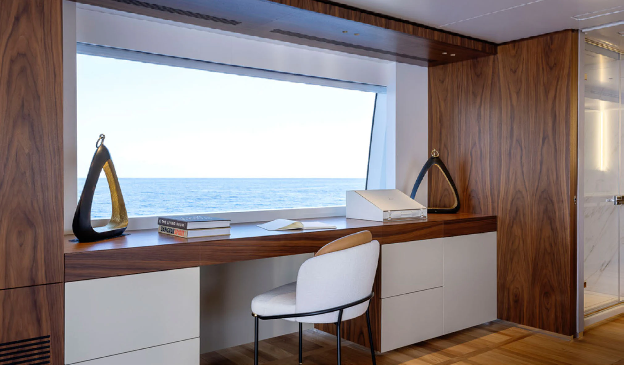 a desk with a chair and a window aboard CADA DIA Yacht for Charter