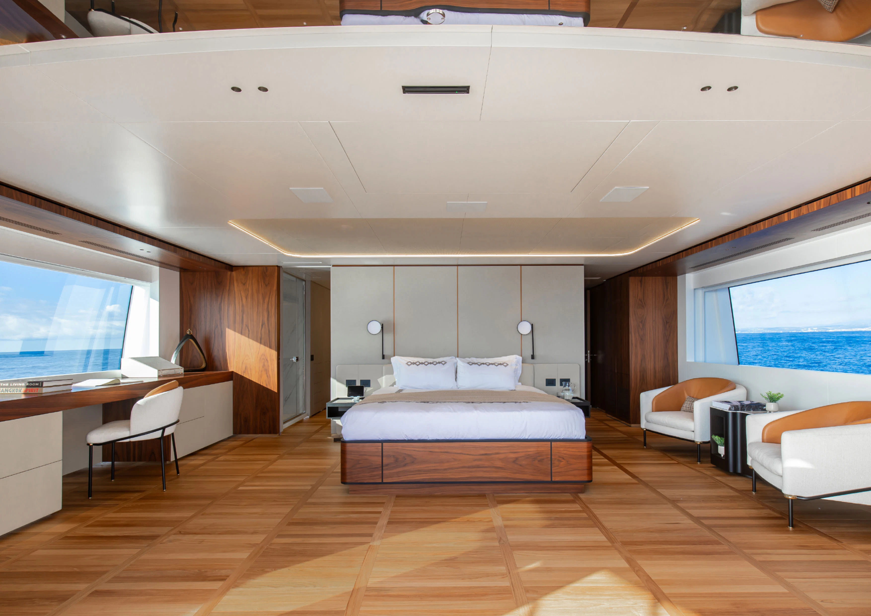 a room with a bed and desk aboard CADA DIA Yacht for Charter
