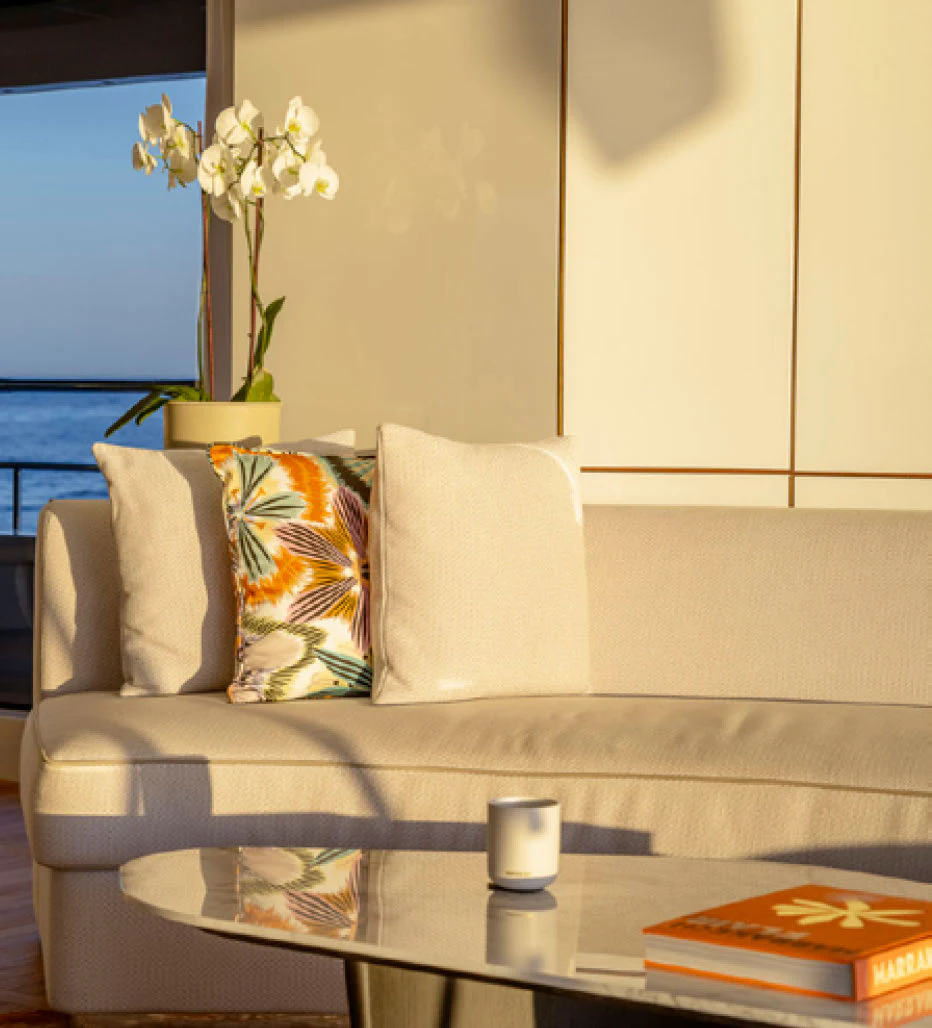 a couch with pillows and flowers aboard CADA DIA Yacht for Charter