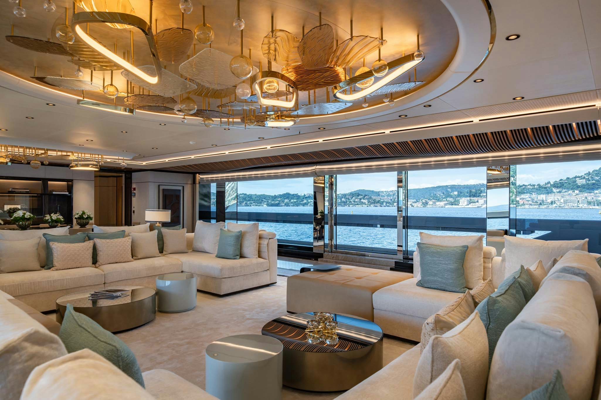 a living room with a large chandelier aboard MALIA Yacht for Charter