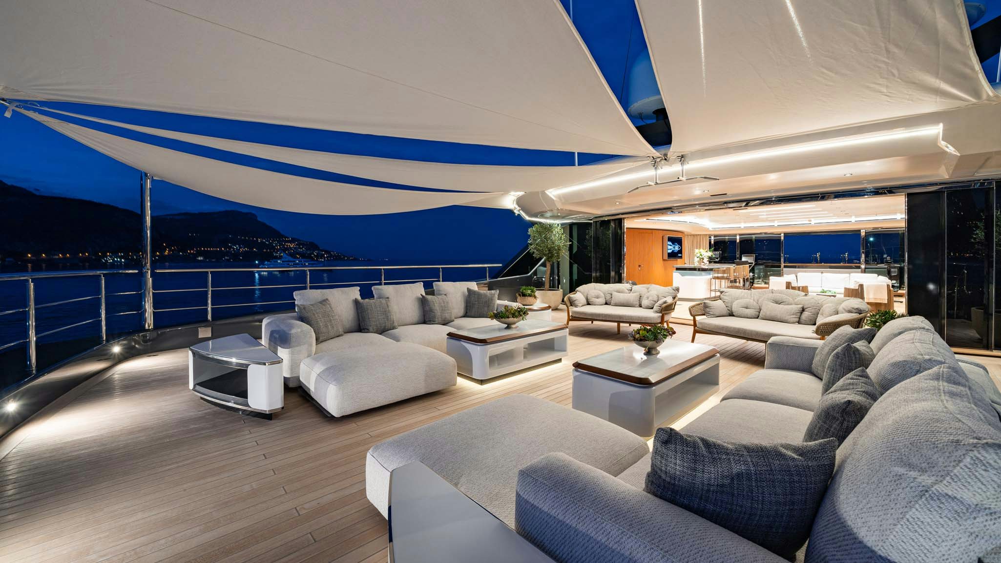a living room with a large blue and white striped tent aboard MALIA Yacht for Charter