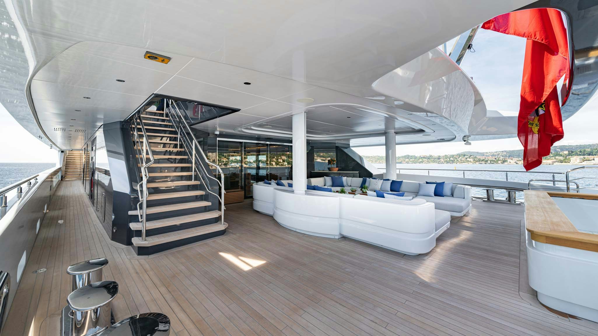a room with a large white staircase and a red and blue rug aboard MALIA Yacht for Charter