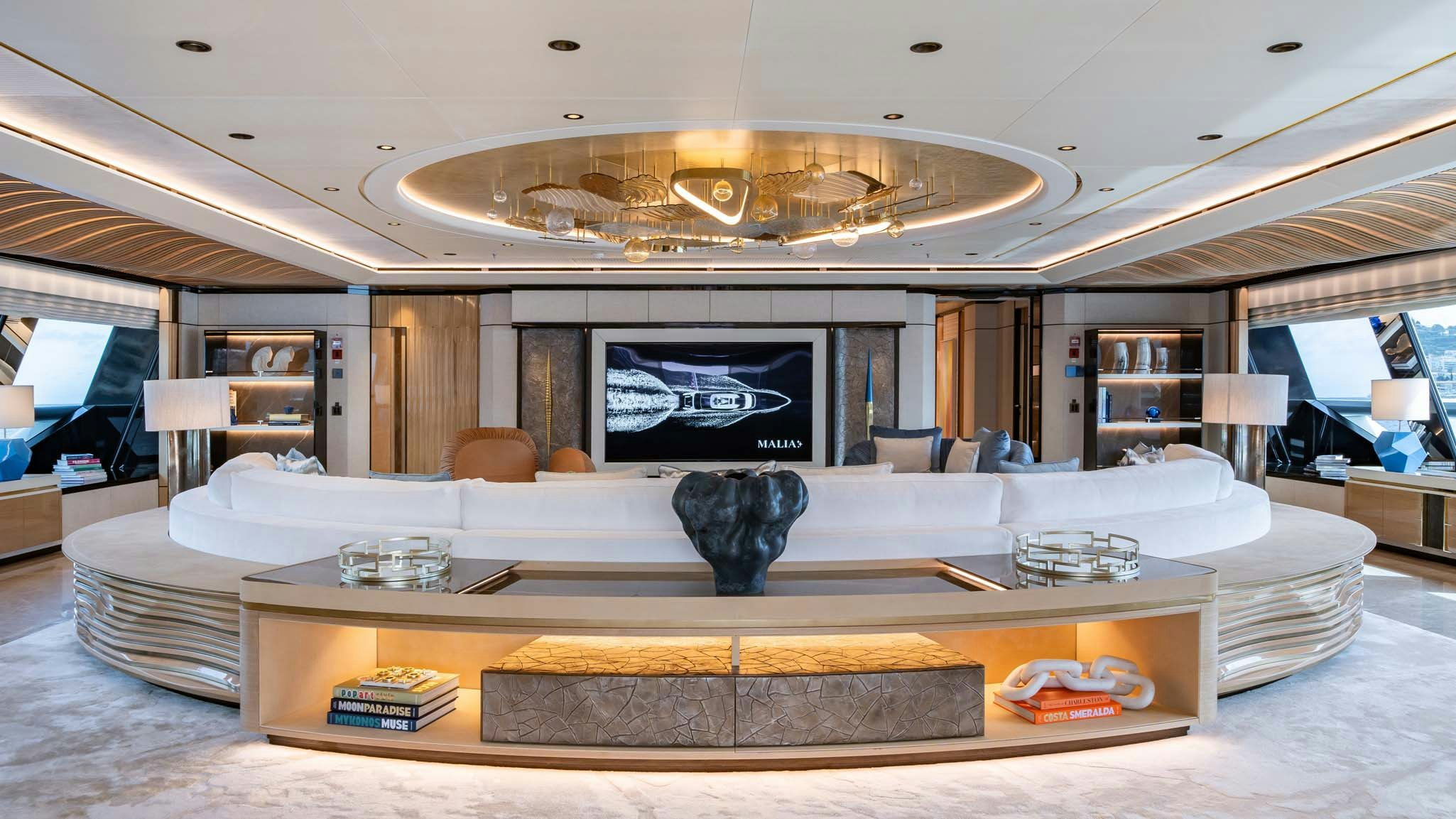 a large living room with a large chandelier aboard MALIA Yacht for Charter