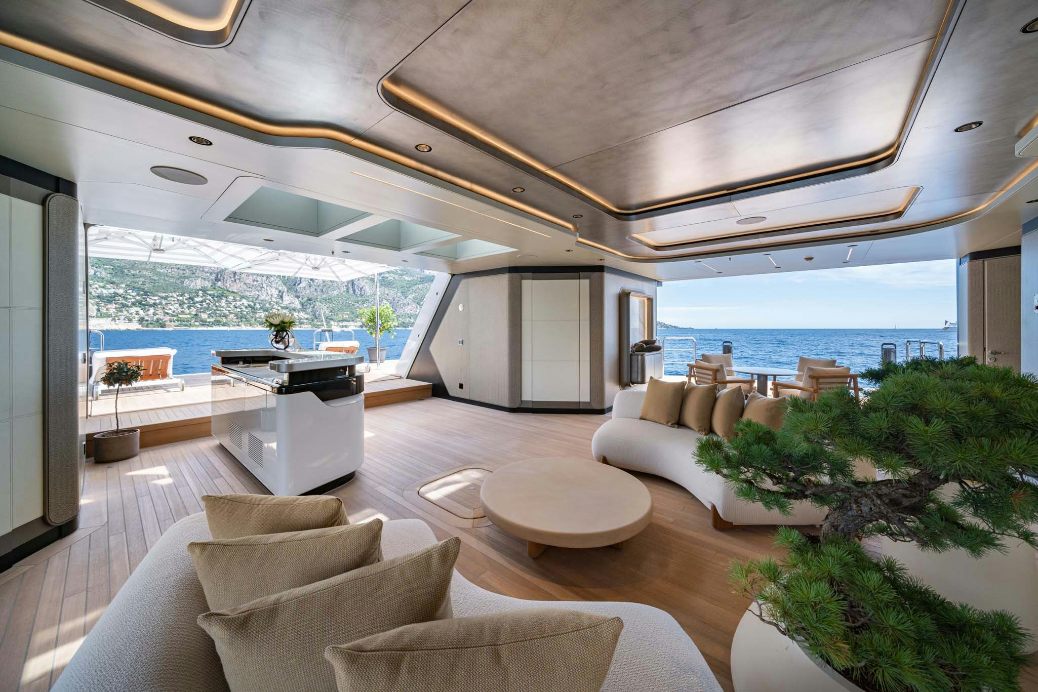 a modern looking living room with a large balcony overlooking the ocean aboard MALIA Yacht for Charter