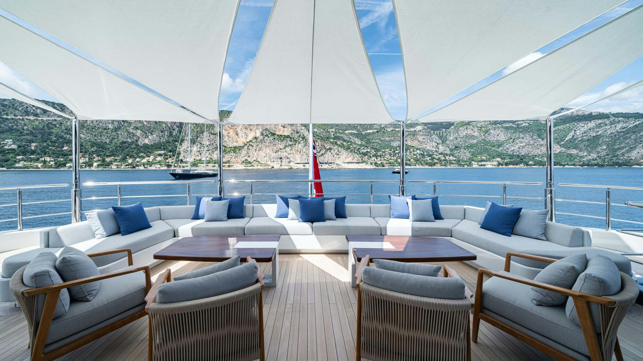 a large patio with a large white umbrella over it aboard MALIA Yacht for Charter