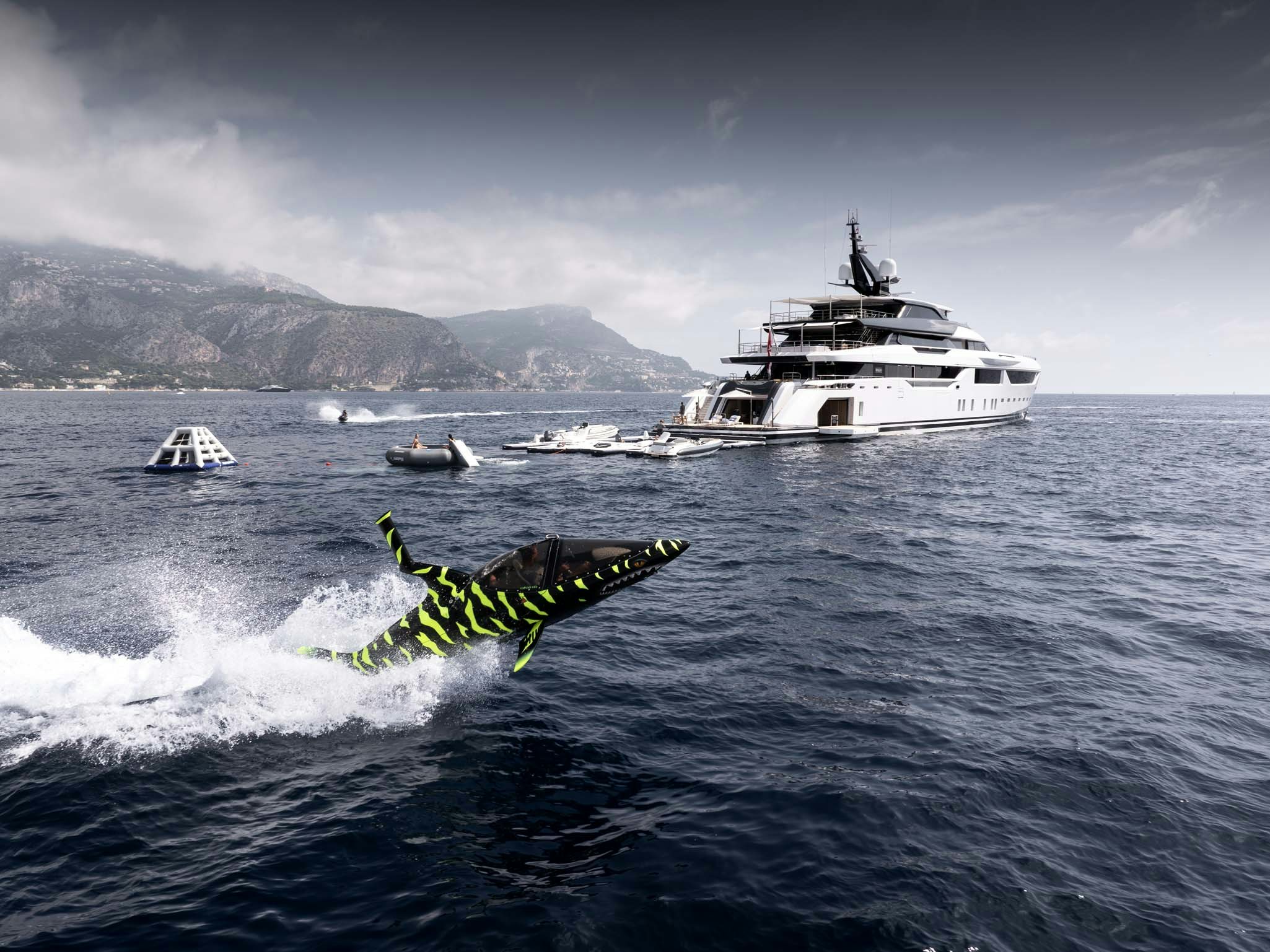 a green and black bug on a white surface with boats in the water aboard MALIA Yacht for Charter