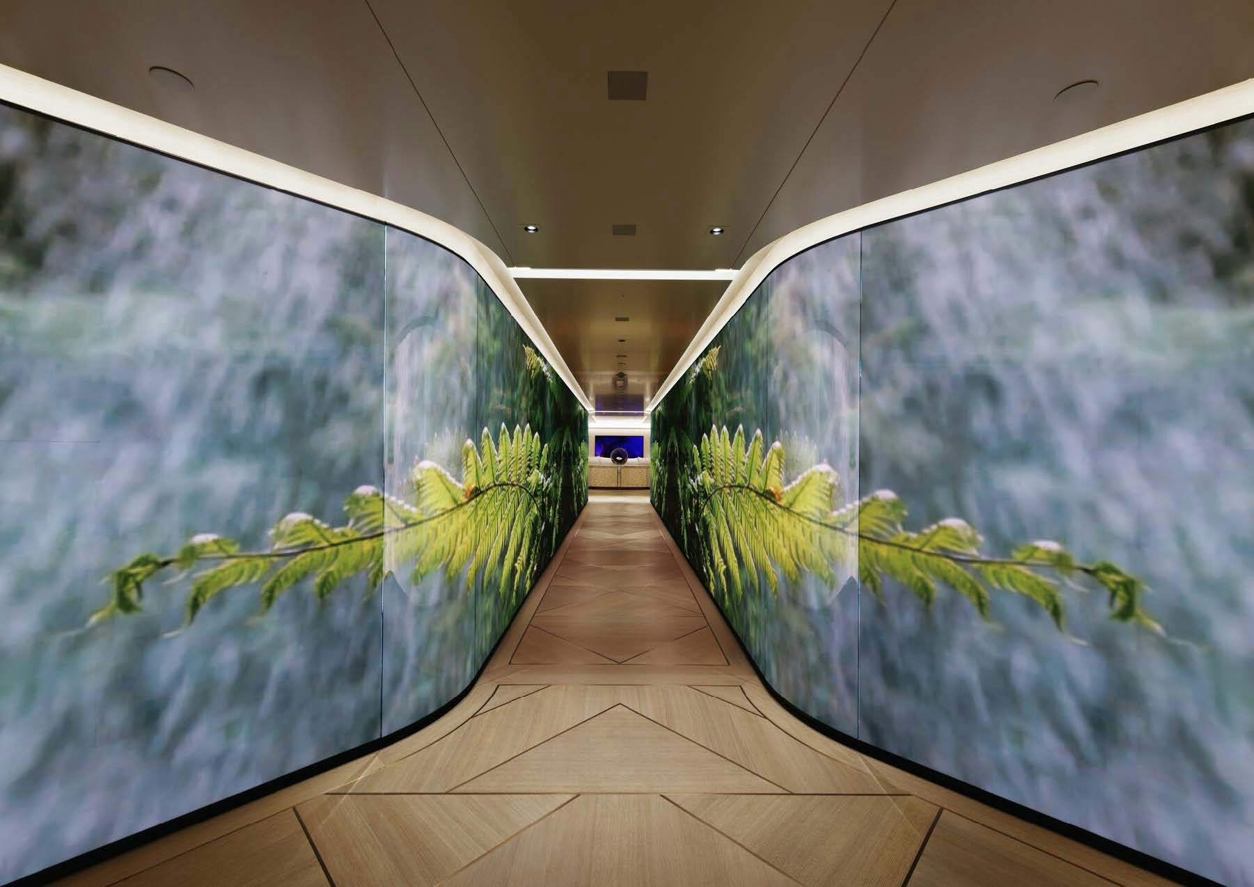 a long hallway with glass walls aboard H3 Yacht for Sale