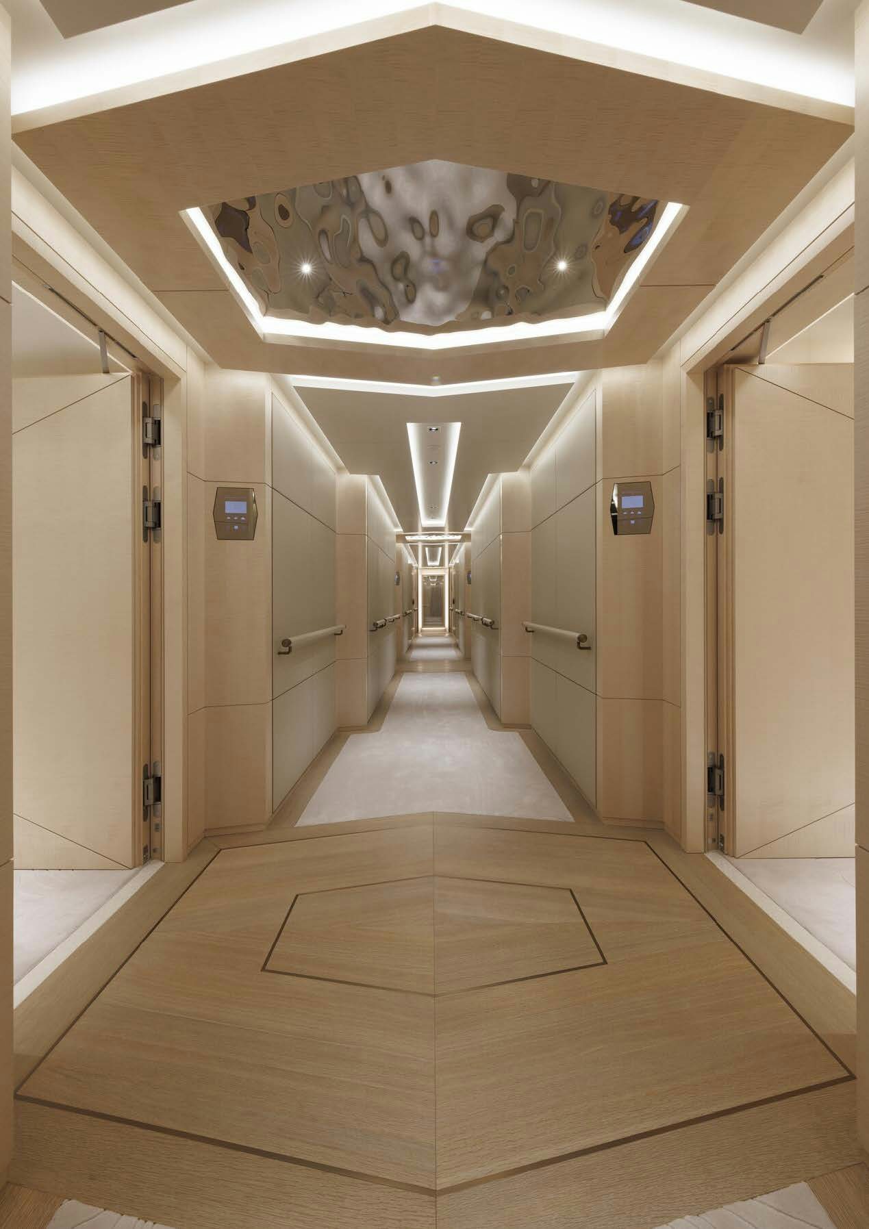 a hallway with a chandelier aboard H3 Yacht for Sale