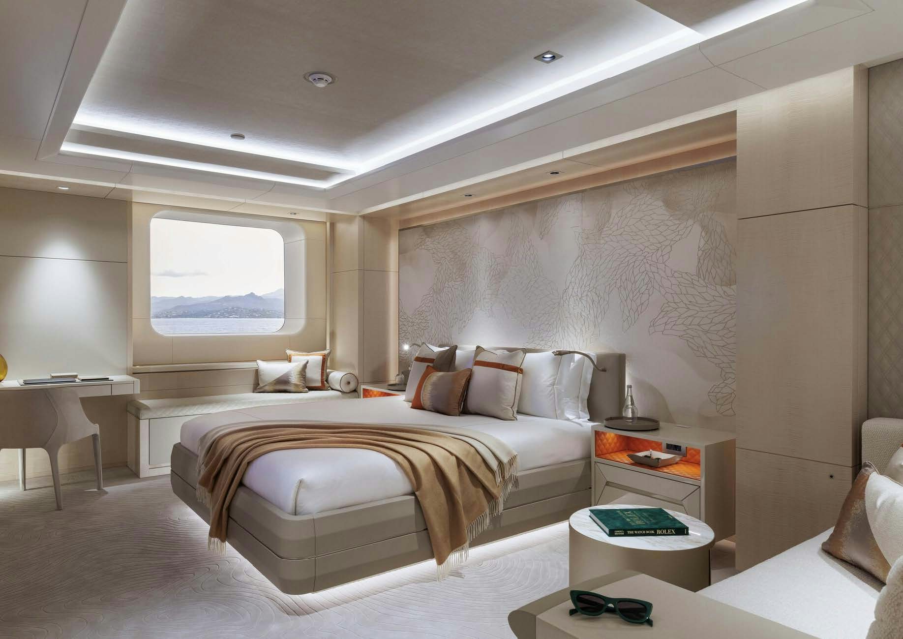 a bedroom with a bed and a desk aboard H3 Yacht for Sale