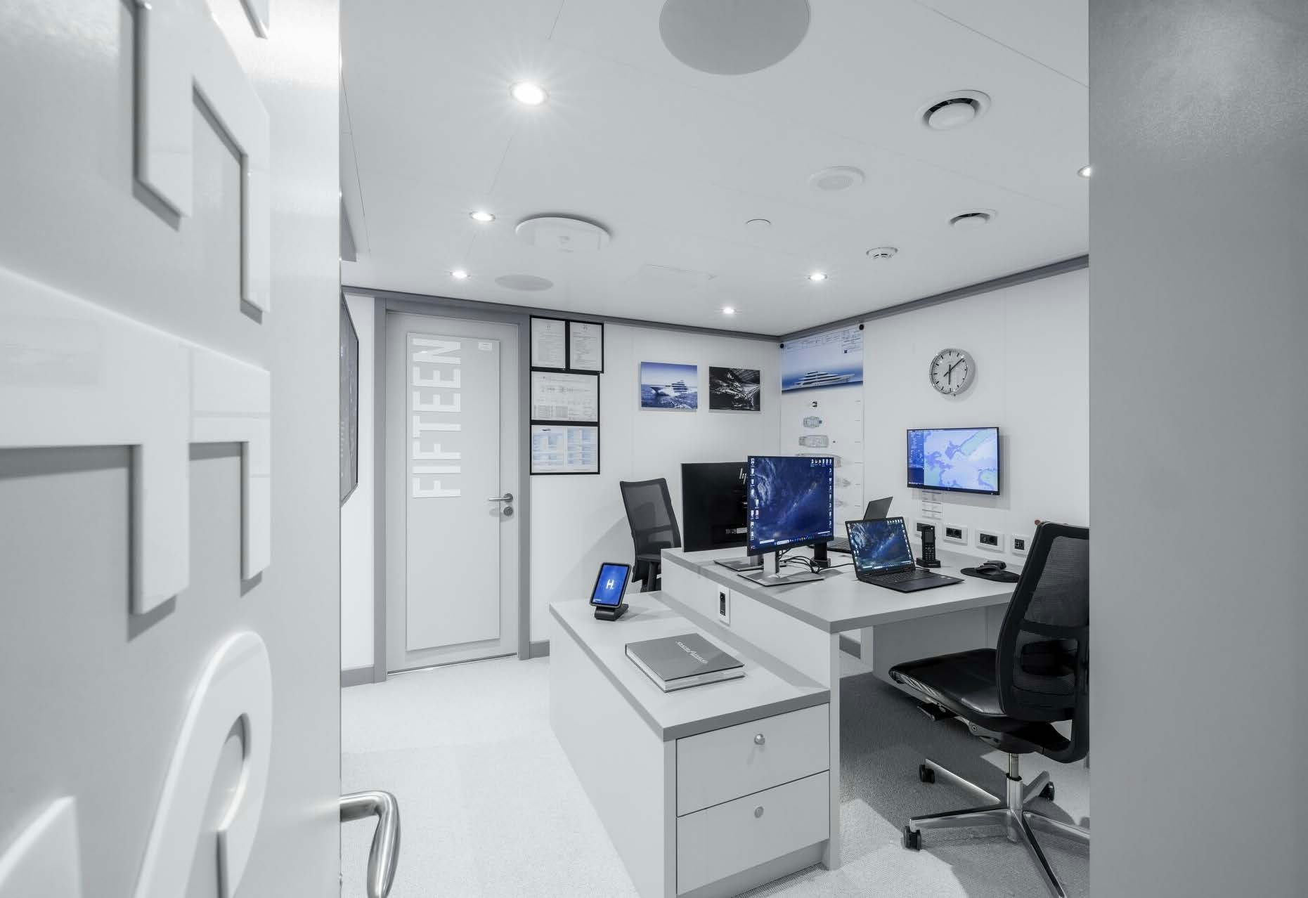 a room with a desk and computer aboard H3 Yacht for Sale