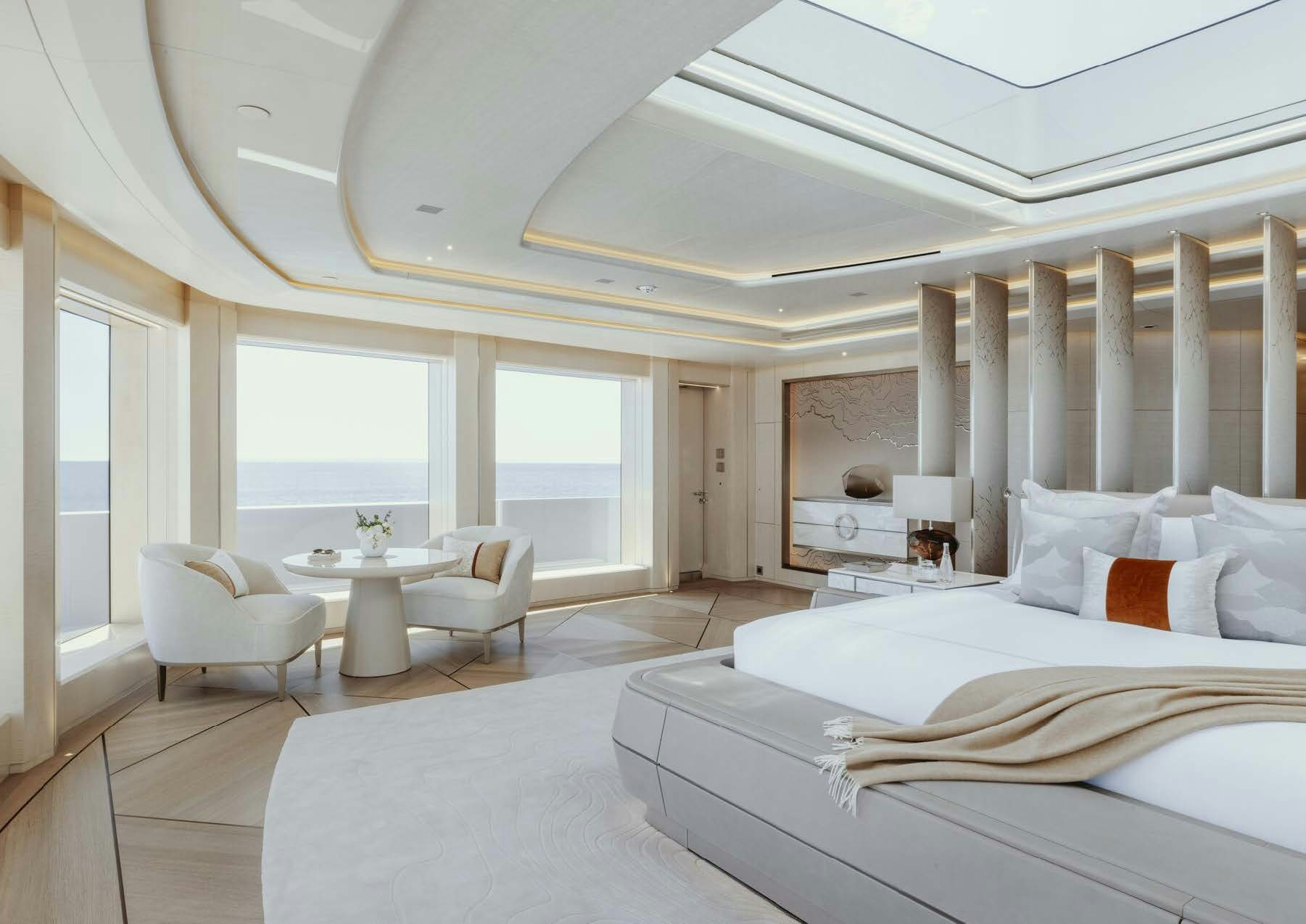 a large white room with a large bed and a table aboard H3 Yacht for Sale