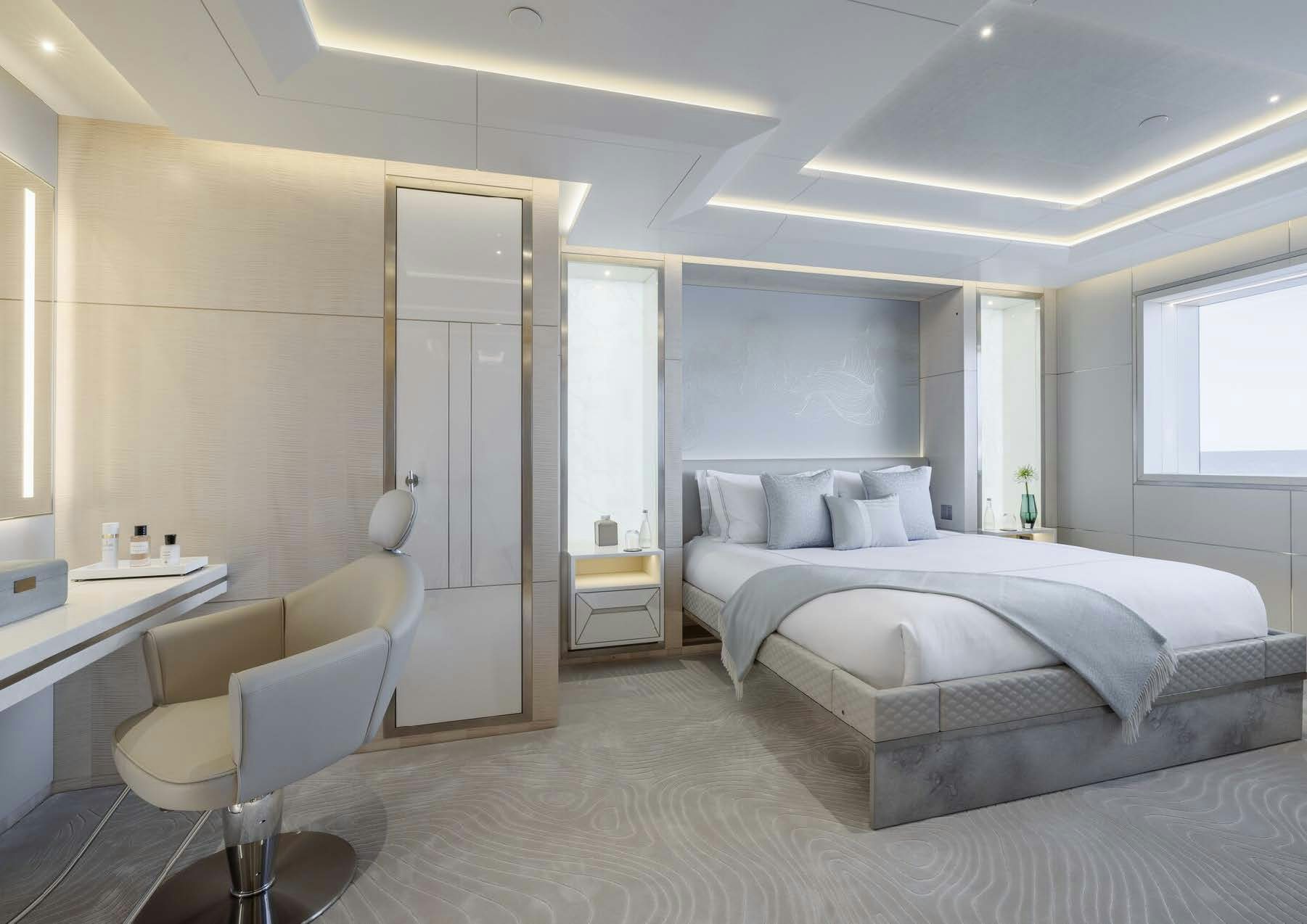a bedroom with a bed and desk aboard H3 Yacht for Sale