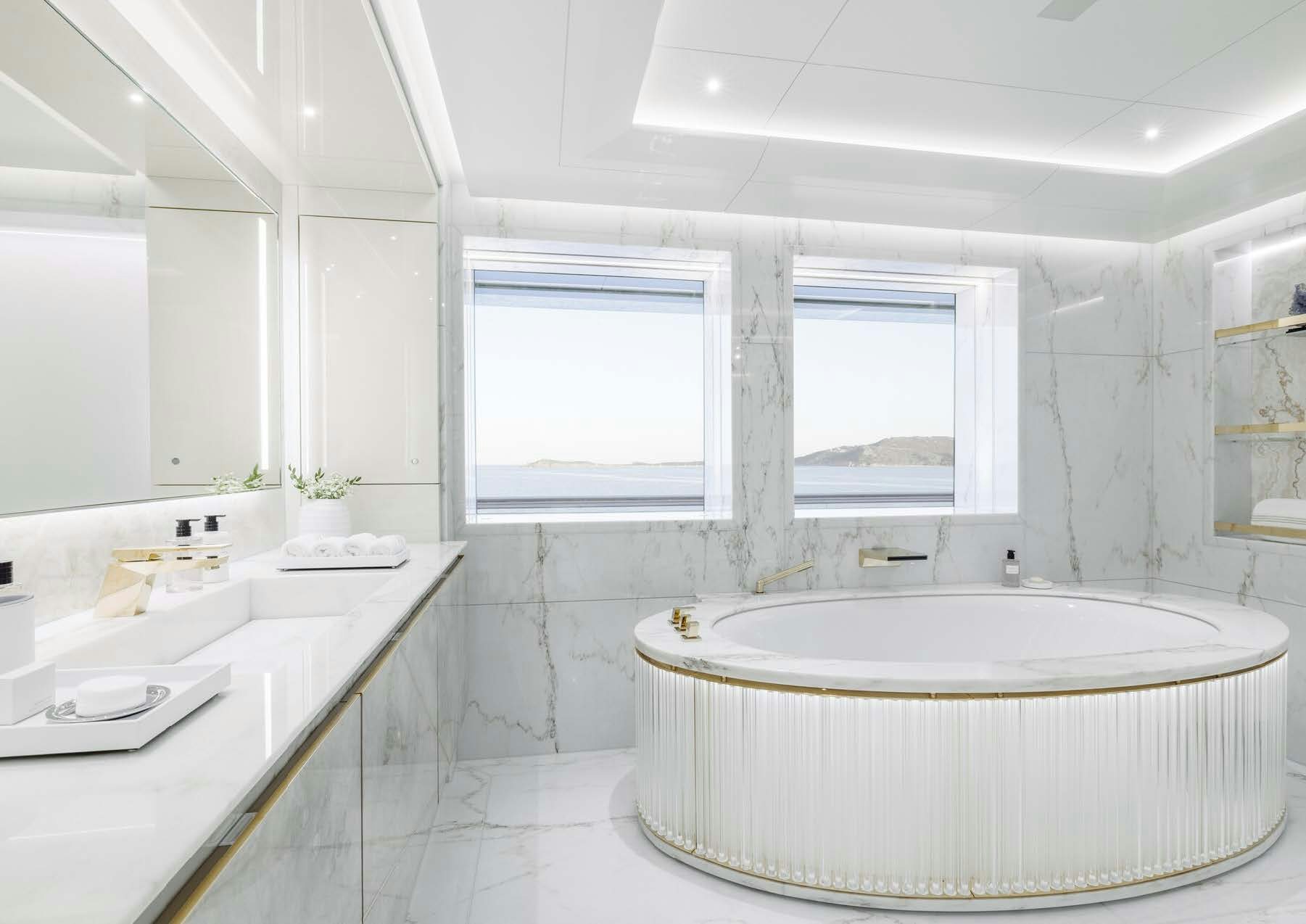 a bathroom with a tub sink and a window aboard H3 Yacht for Sale