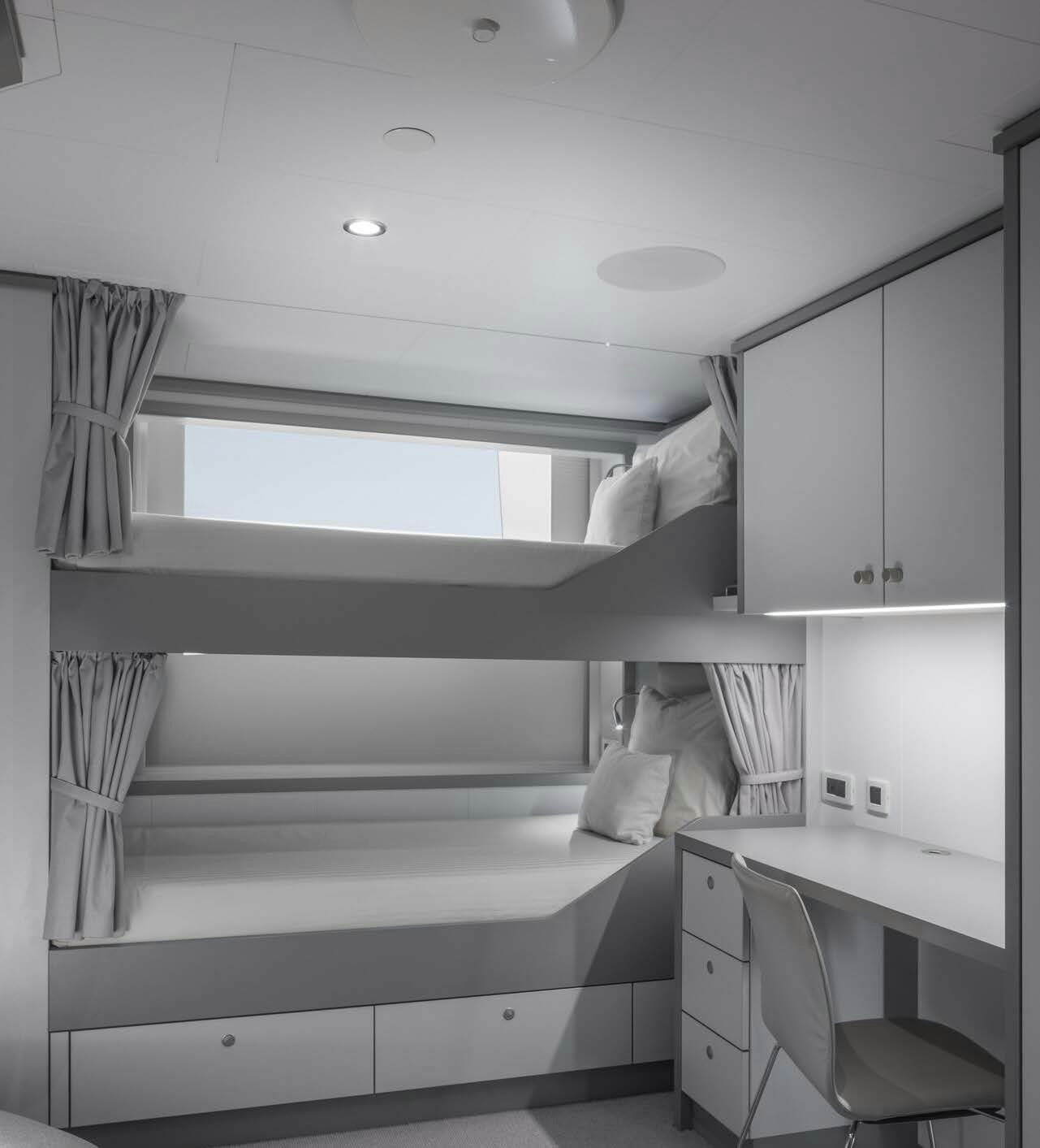 a white bedroom with a white bed aboard H3 Yacht for Sale