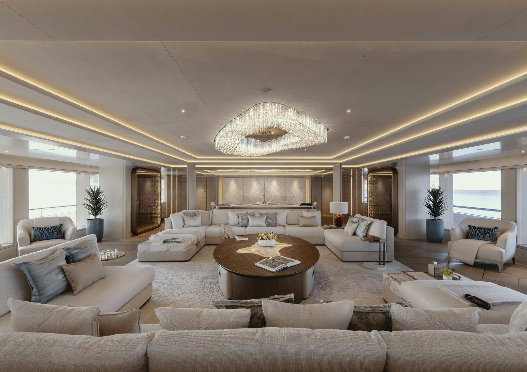 a large living room with a large chandelier aboard H3 Yacht for Sale
