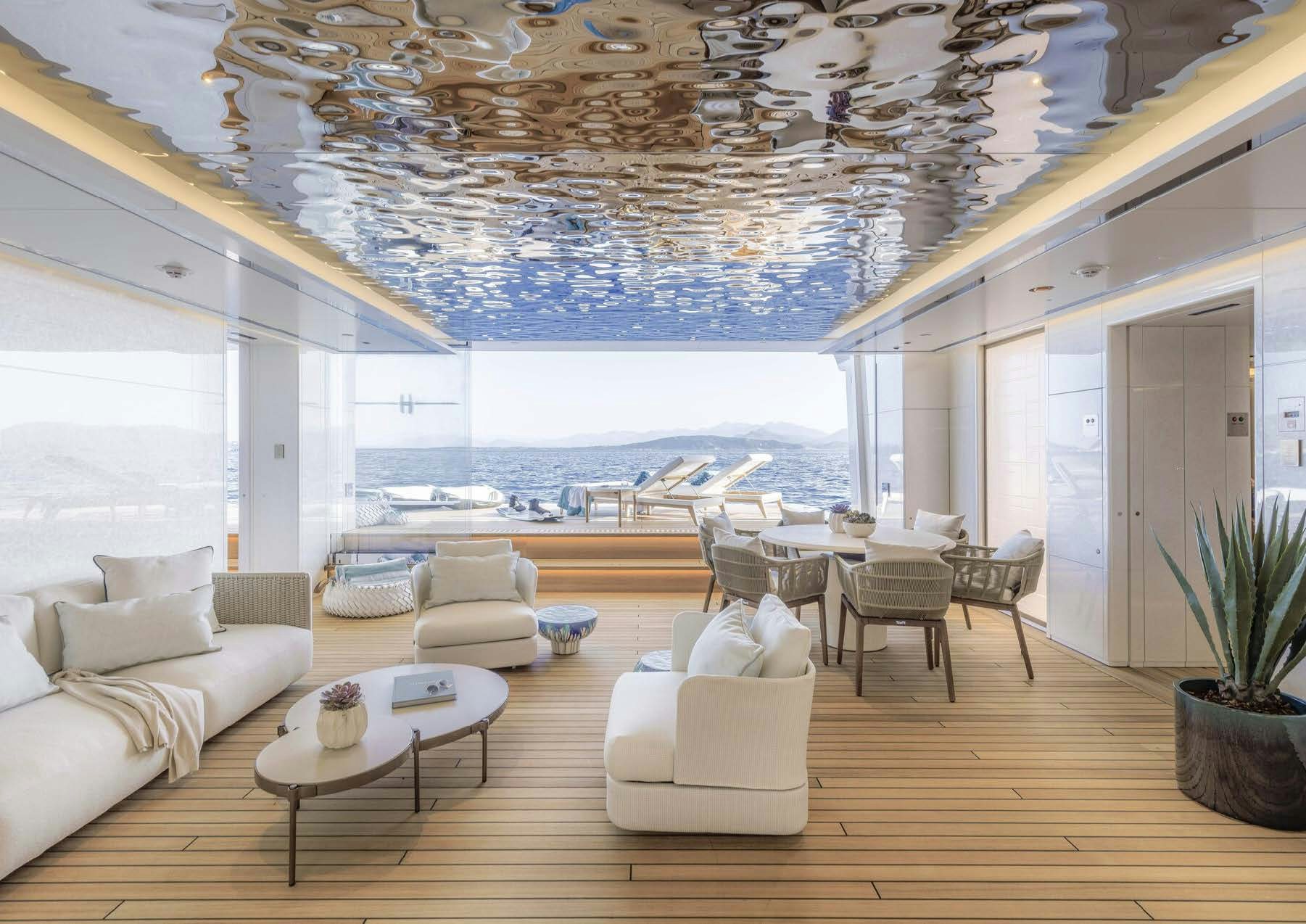 a large living room with a large chandelier aboard H3 Yacht for Sale