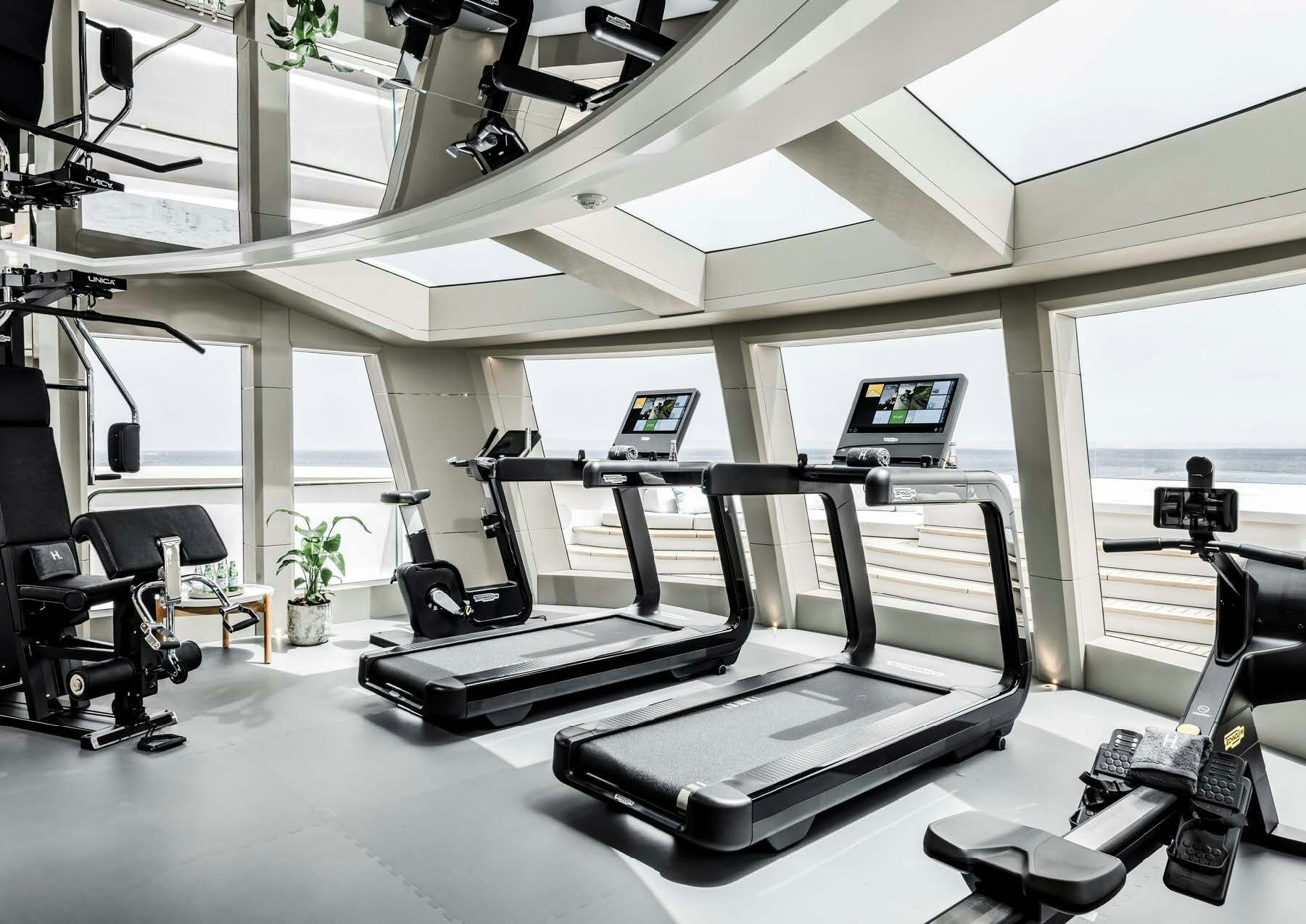 a room with treadmills and a laptop aboard H3 Yacht for Sale