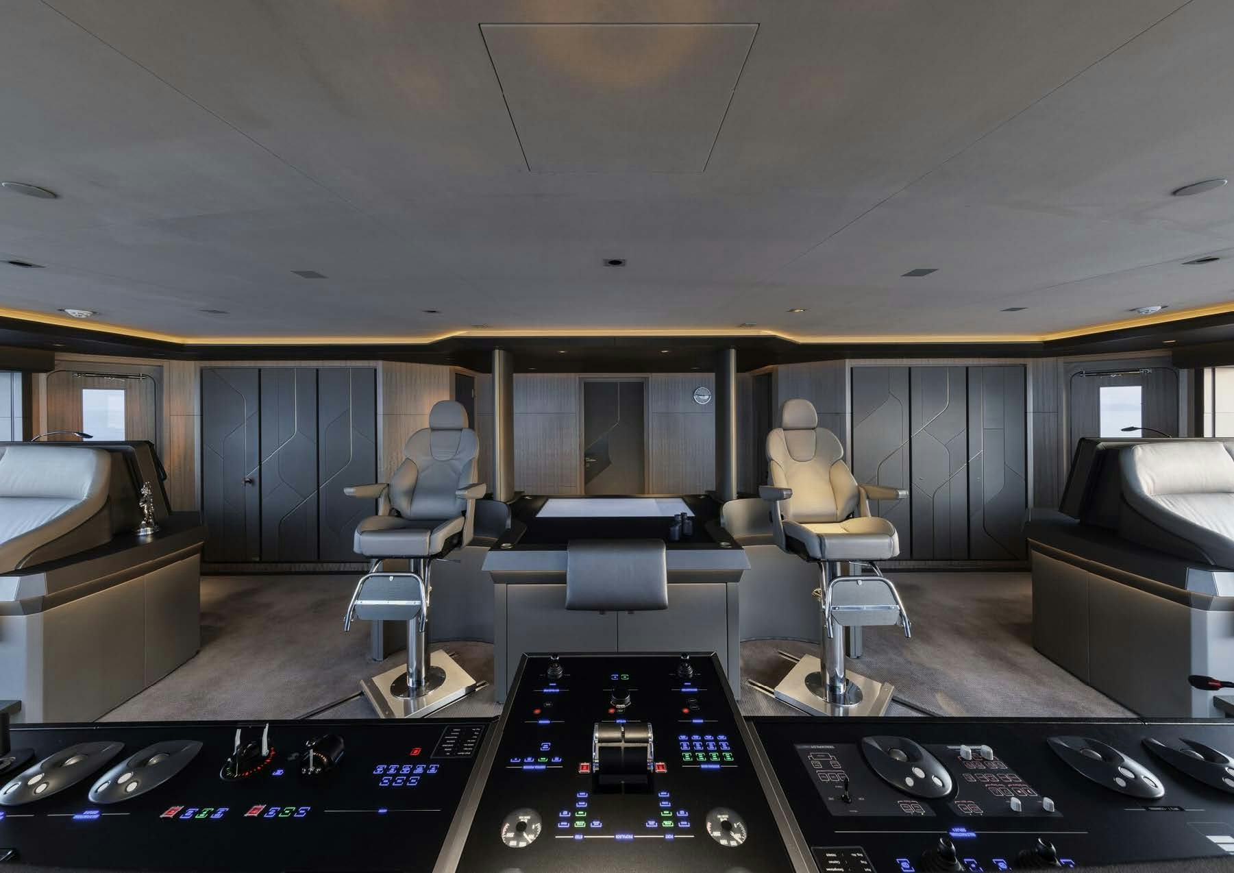 a room with a table and chairs aboard H3 Yacht for Sale