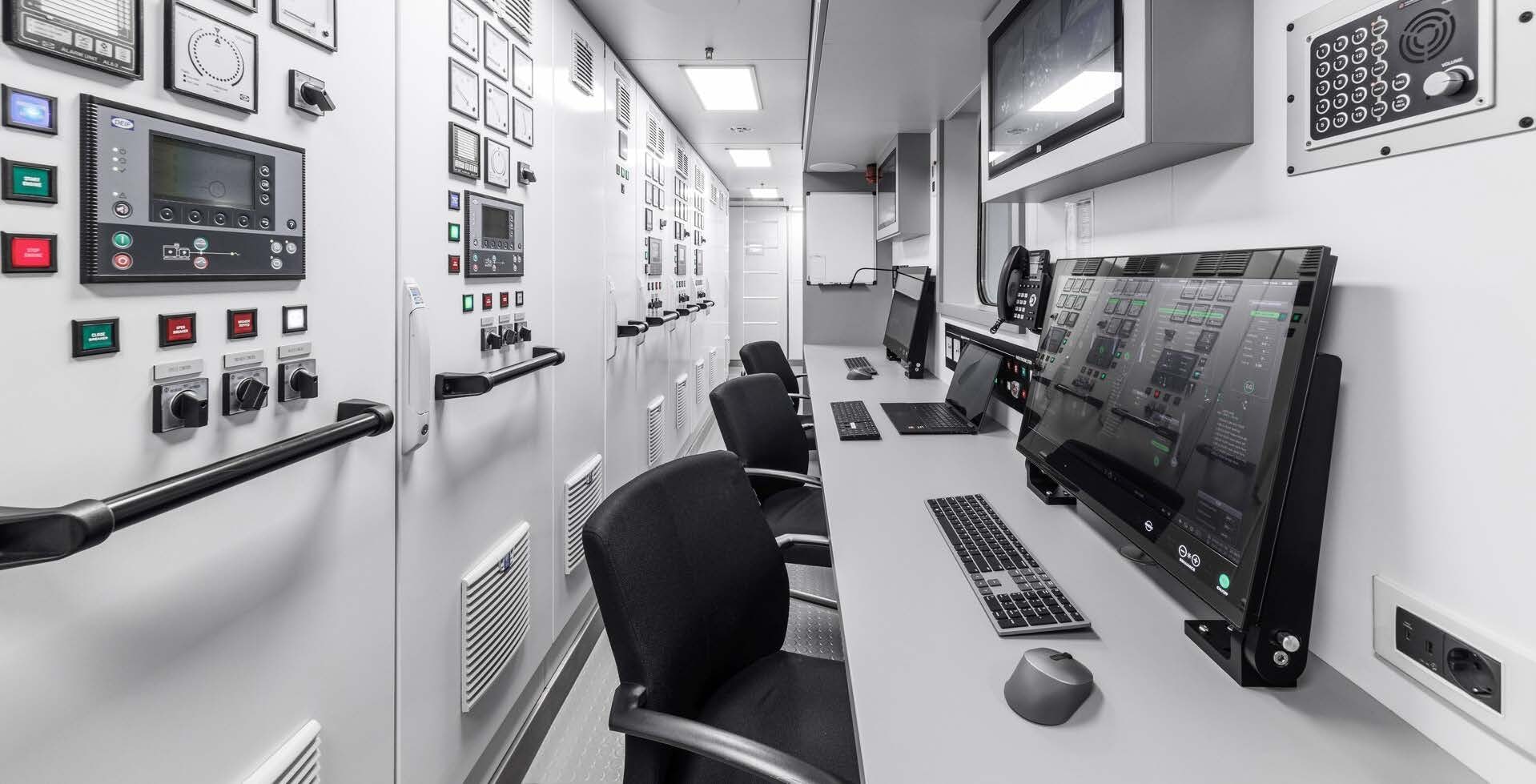 a room with computers and chairs aboard H3 Yacht for Sale