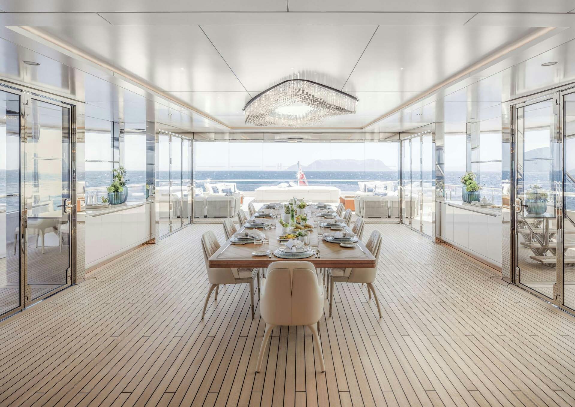a room with a table and chairs aboard H3 Yacht for Sale